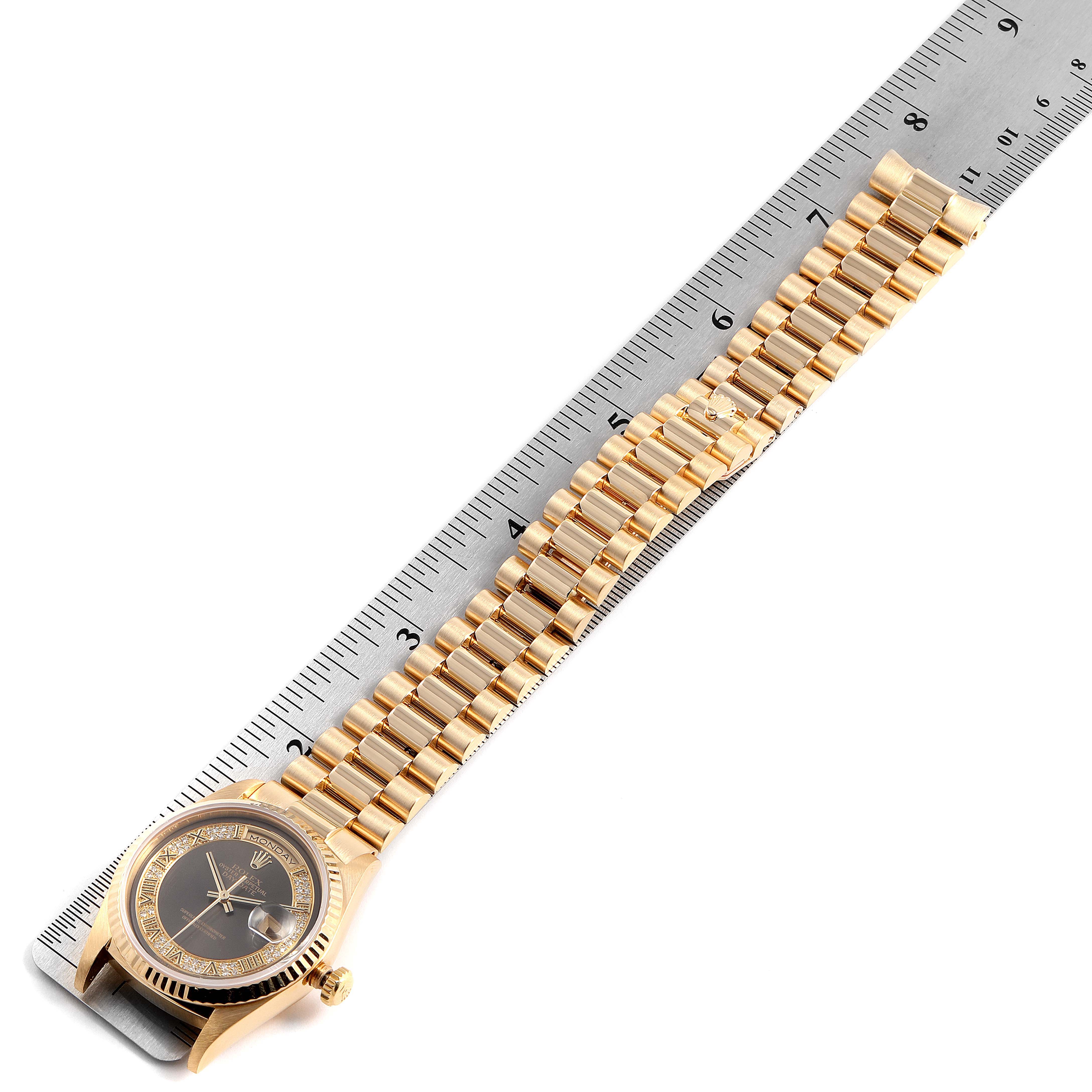The image shows a Rolex President 18238 Men's Yellow Gold Brown Dial 18238 Men's Yellow Gold Brown Dial model watch laid flat on a ruler, displaying its watch face, band, and clasp.