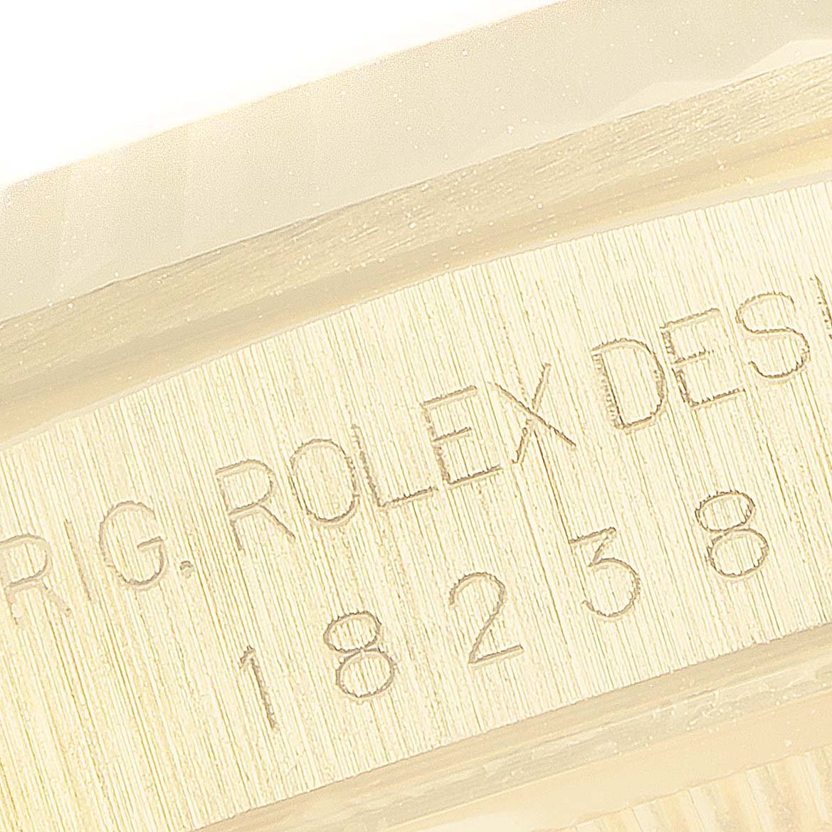 This close-up image shows the engraved serial number and design details on the case of a Rolex President 18238 Men
s Yellow Gold Champagne Dial 18238 Men
s Yellow Gold Champagne Dial model watch.