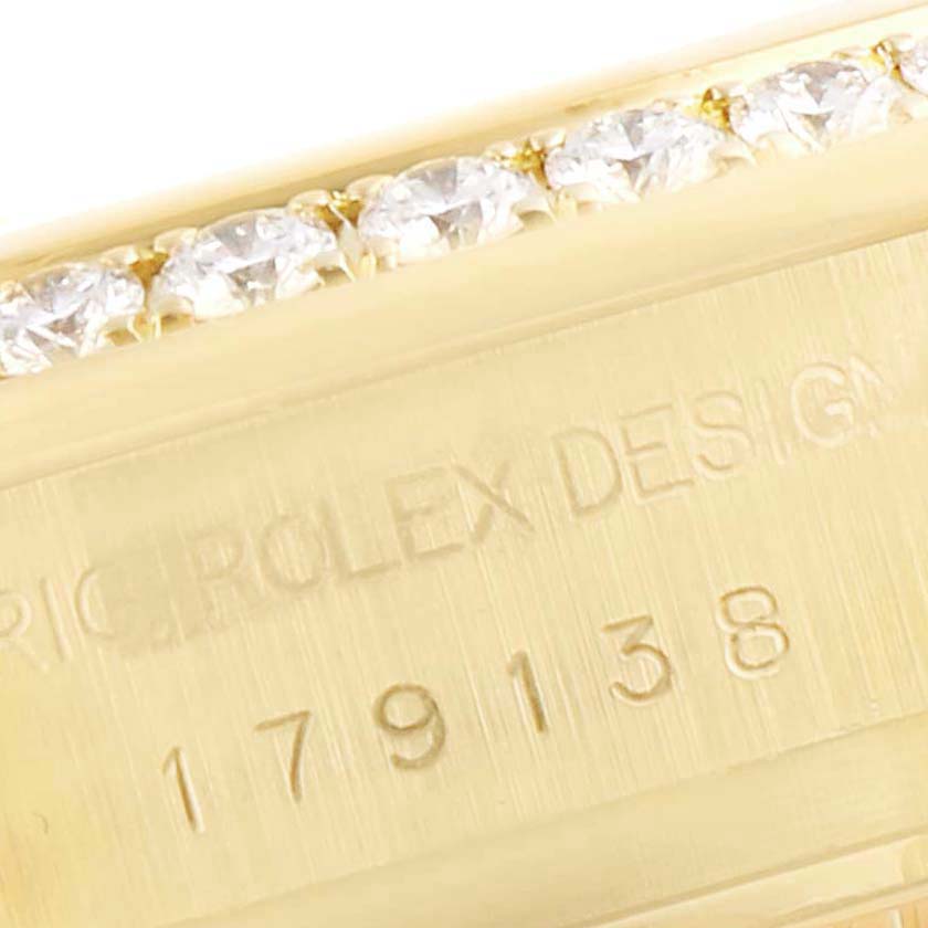 This image shows the side view of a Rolex President 179138 Women
s Yellow Gold Mother of Pearl Dial 179138 Women
s Yellow Gold Mother of Pearl Dial model watch case with the engravings and part of a diamond bezel visible.