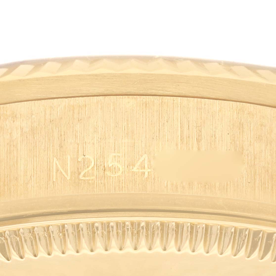 The image shows a close-up of the engraved serial number on the case of a Rolex President 68278 Women's Yellow Gold Champagne Dial 68278 Women's Yellow Gold Champagne Dial model watch.