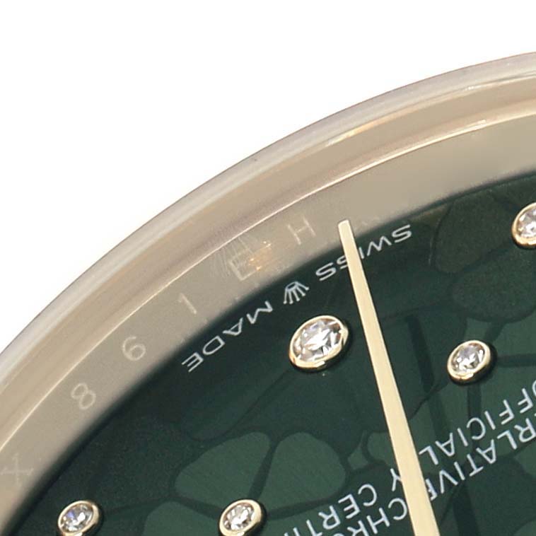 The image shows a close-up of a Rolex President 278278 Women
s Yellow Gold Green Dial model watch dial, displaying the bezel, part of the face, and diamond markers.
