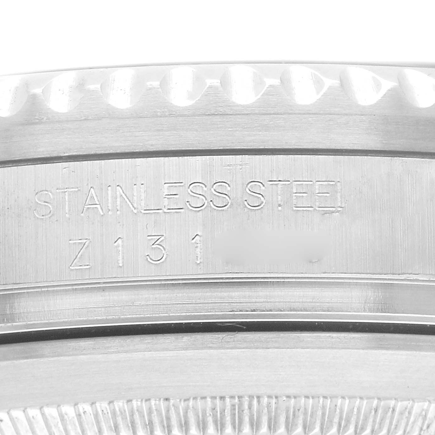 The image shows a close-up of the stainless steel case part of the Rolex Sea-Dweller 16600 Men's Stainless Steel Black Dial, focusing on engravings and textures.