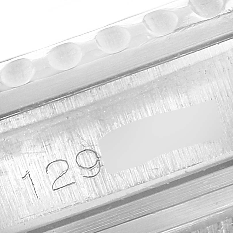 The close-up image shows a partial view of the bezel and serial number engraving of the Vintage Collection model by Rolex.