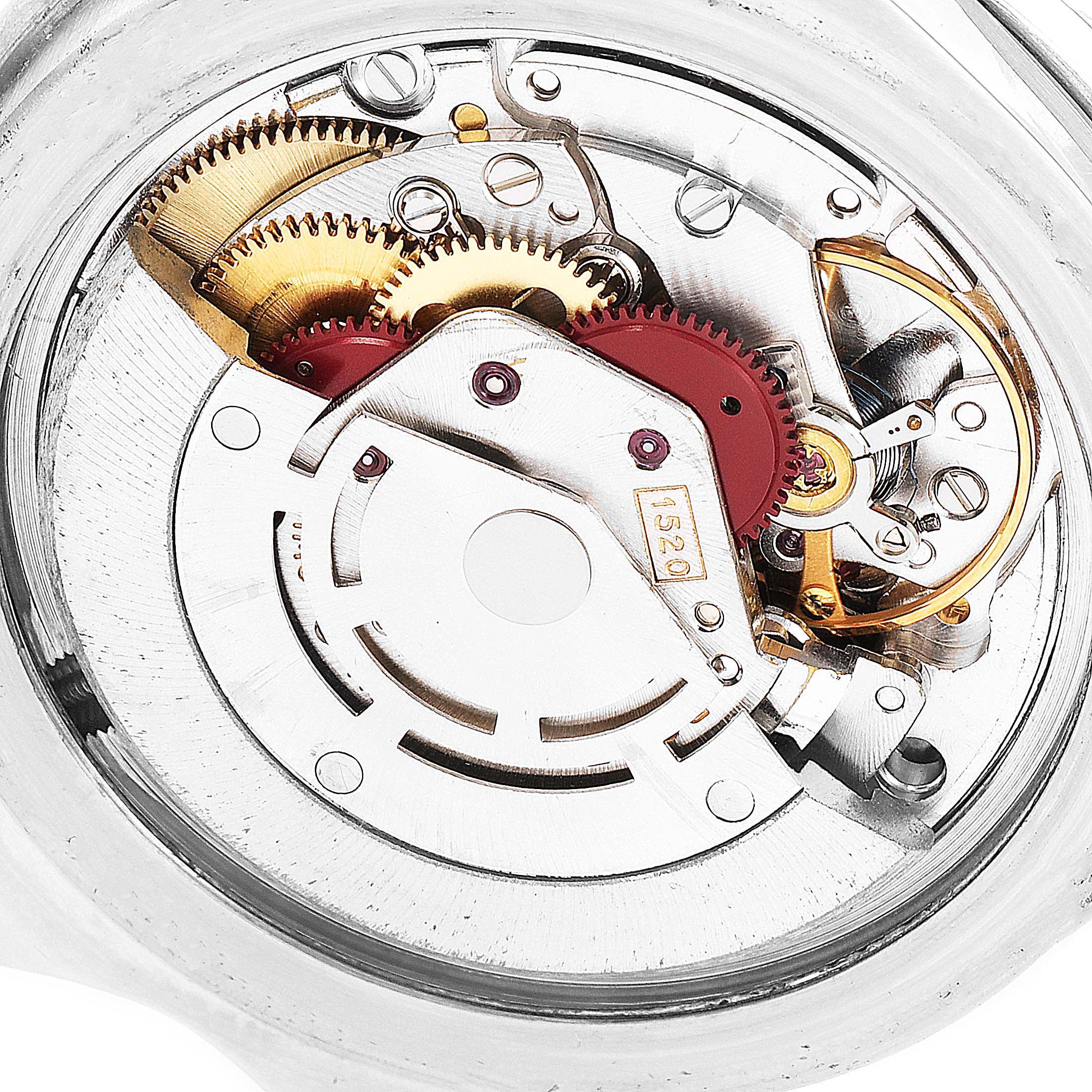 The image shows the intricate internal mechanisms of a Vintage Collection model by Rolex, focusing on gears and components of the movement.