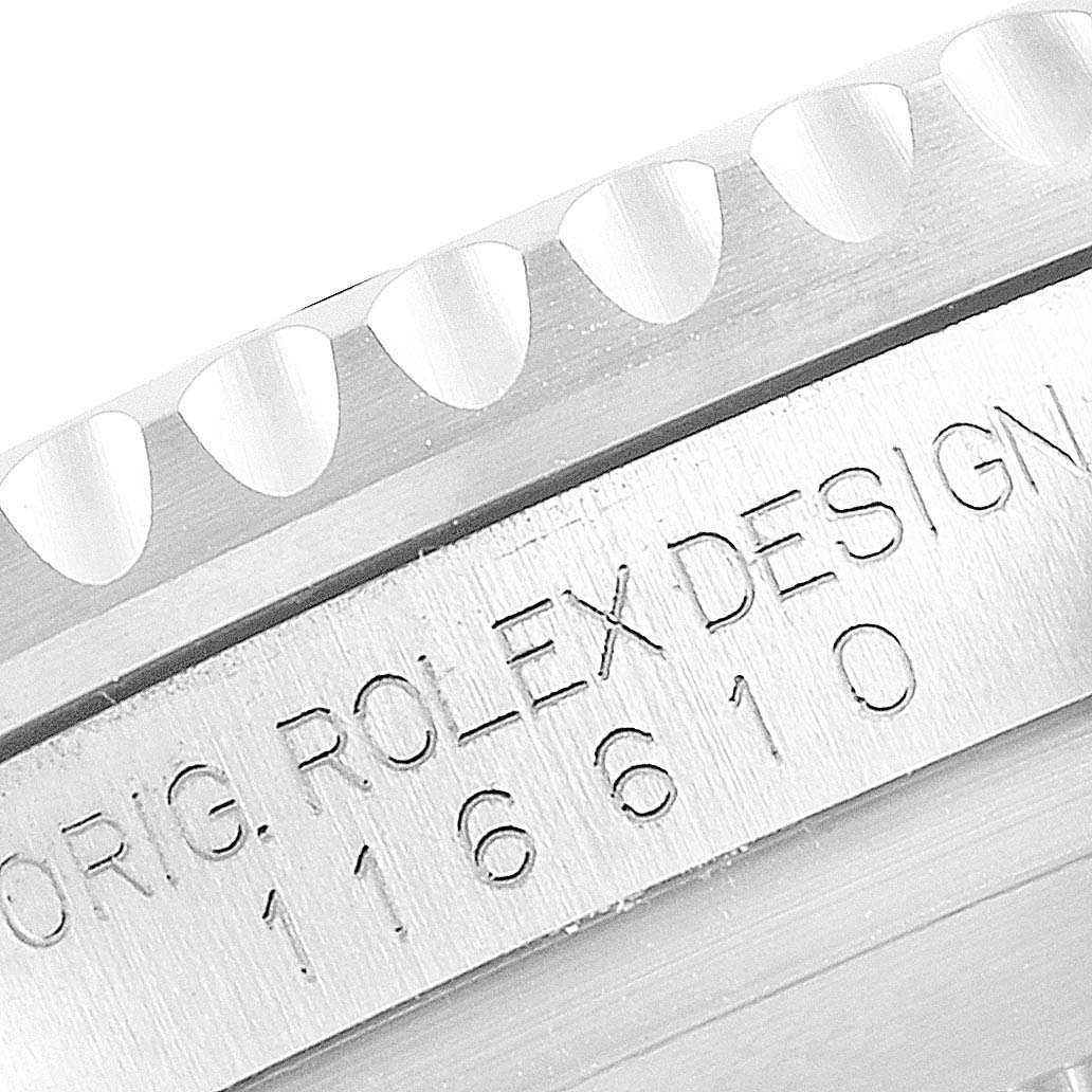 The image shows a close-up view of the engraved serial number and bezel of a Rolex Submariner 116610 Men's Stainless Steel Black Dial 116610 Men's Stainless Steel Black Dial watch.