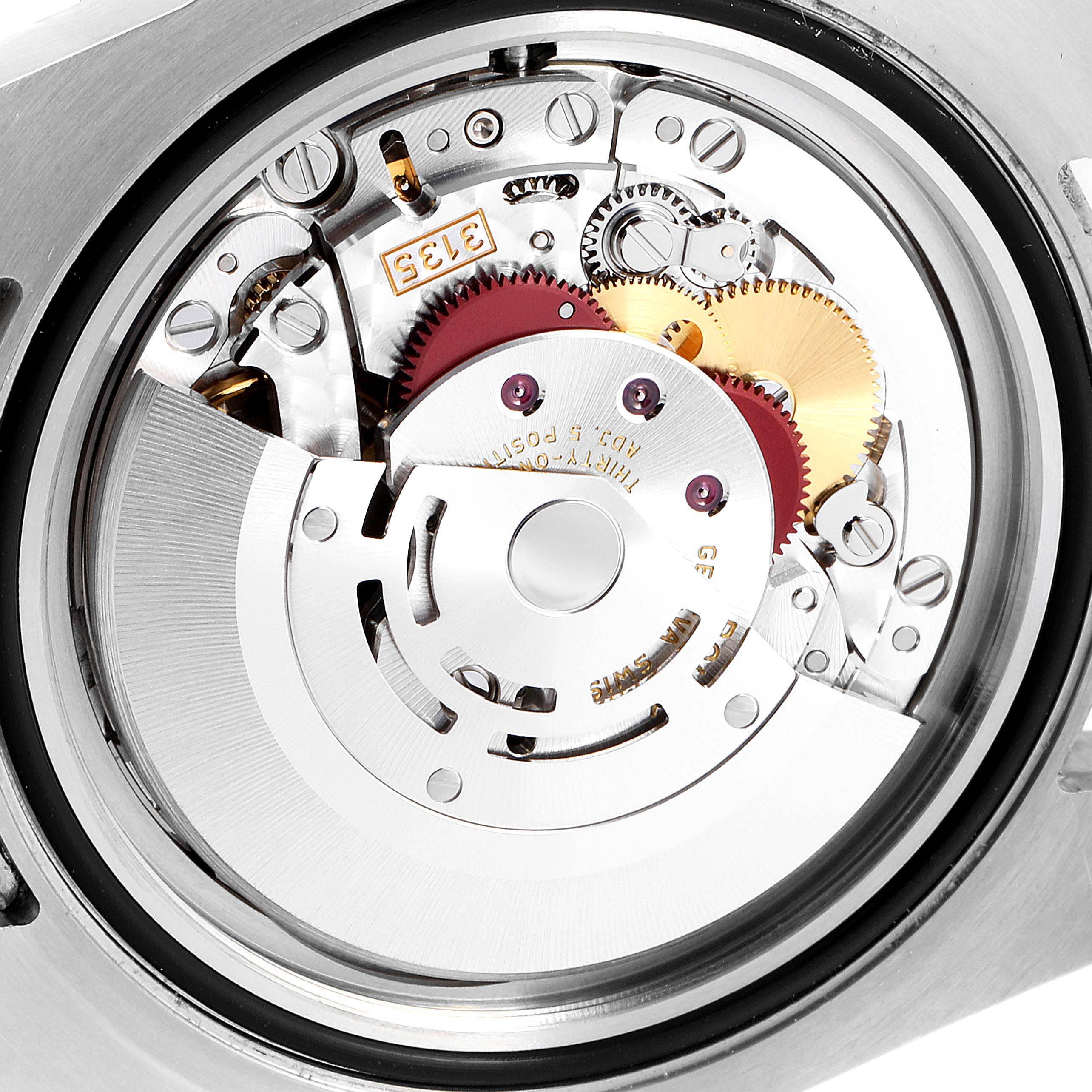 The image shows the intricate inner mechanism of a Rolex Submariner 116610 Men's Stainless Steel Black Dial 116610 Men's Stainless Steel Black Dial watch, focusing on the movement components.