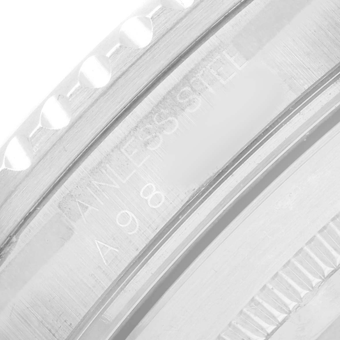 The image shows a close-up of the side of the bezel and part of the case band of a Rolex Submariner 16610 Men's Stainless Steel Black Dial, highlighting the engravings and serrations.