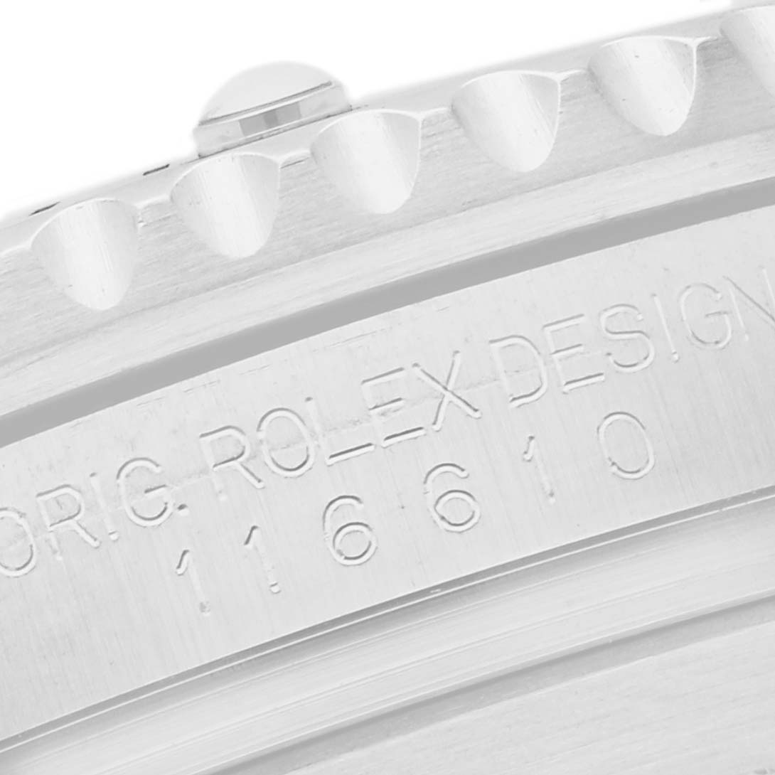 The image shows a close-up of the bezel edge and engraved serial number on a Rolex Submariner 116610 Men
s Stainless Steel Black Dial watch.