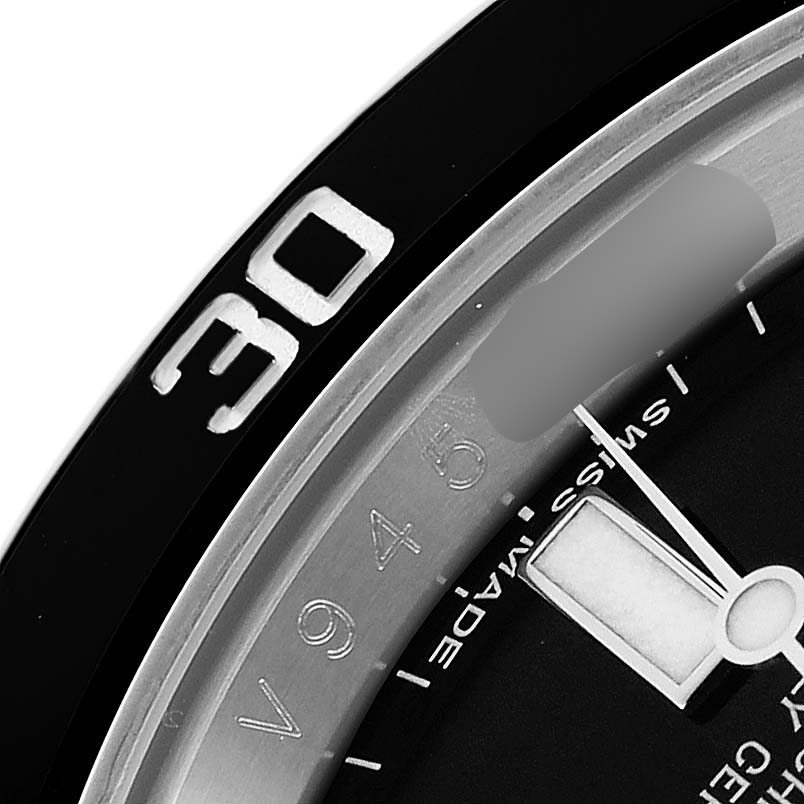 The image shows a close-up of the Rolex Submariner 116610 Men
s Stainless Steel Black Dial
s bezel edge, a portion of the dial, and the minute hand.