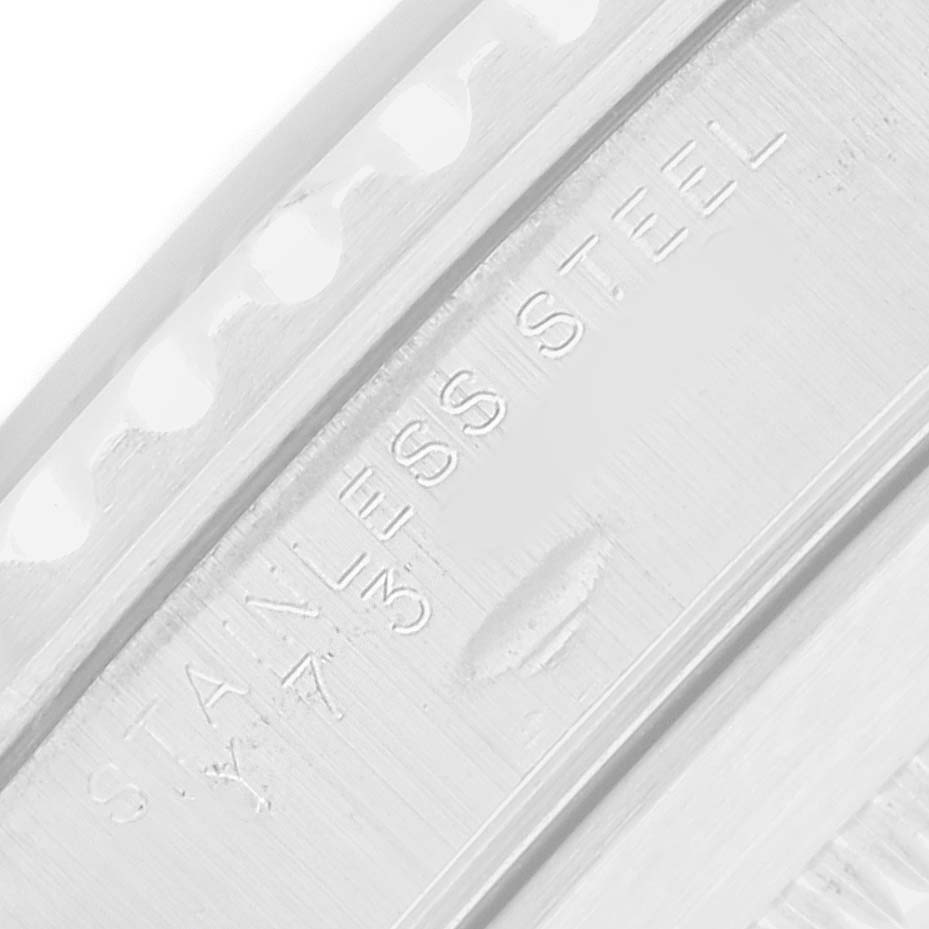 The image shows a close-up of the side of a Rolex Submariner 14060M Men
s Stainless Steel Black Dial watch case, featuring the "STAINLESS STEEL" engraving.