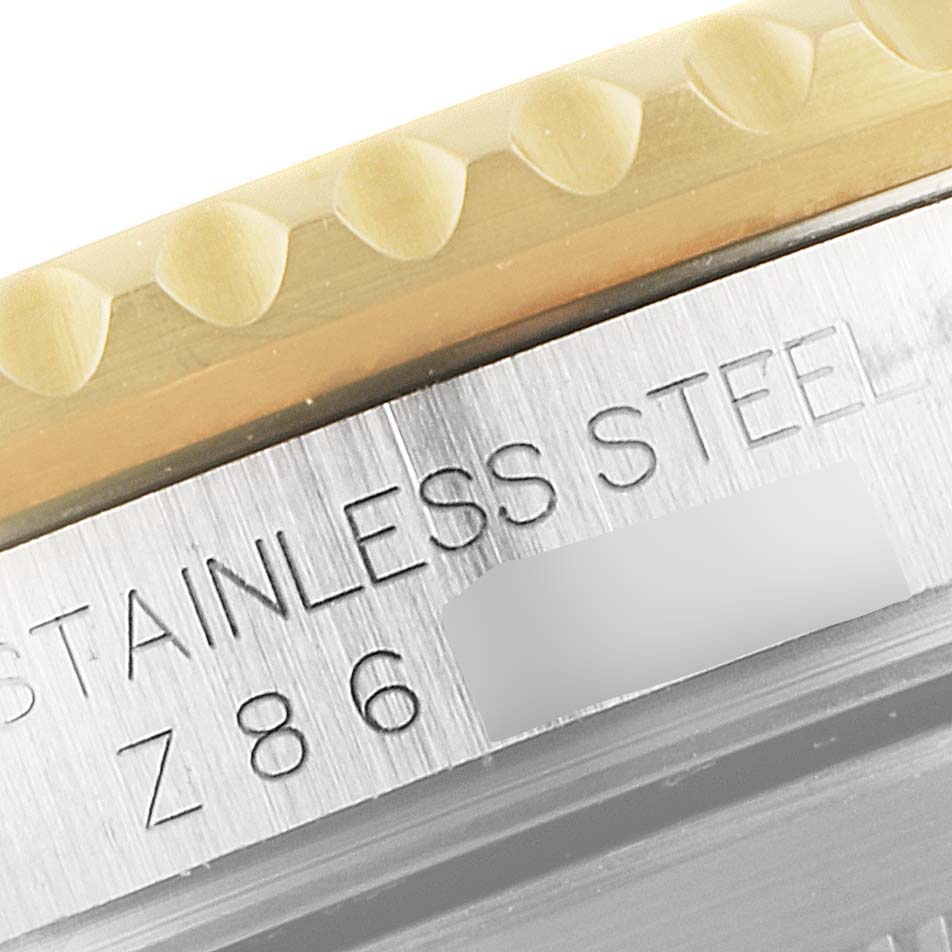 The close-up image shows part of the bezel and the engraved serial number on the side of the Rolex Submariner 16613 Men
s Steel and Gold (two tone) Grey Dial 16613 Men
s Steel and Gold (two tone) Grey Dial watch case.