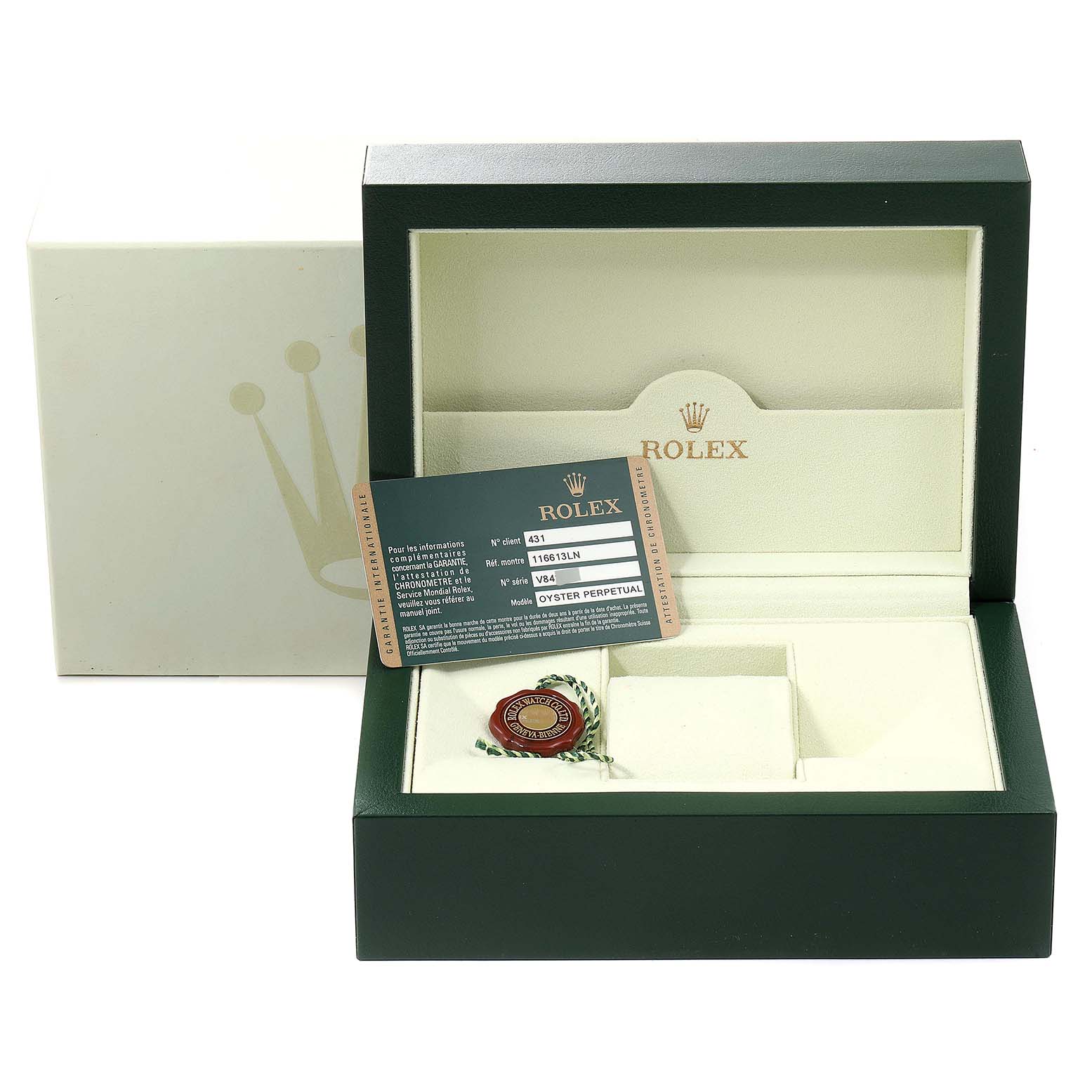 The image shows an open green Rolex watch box for a Submariner model, including the warranty card and a red tag.