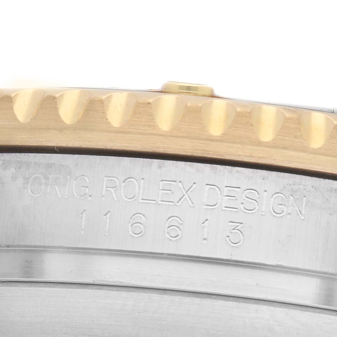 The image shows a close-up of the Rolex Submariner 116613 Men
s Steel and Gold (two tone) Black Dial
s engraved side with the model number 116613, alongside the bezel edge.