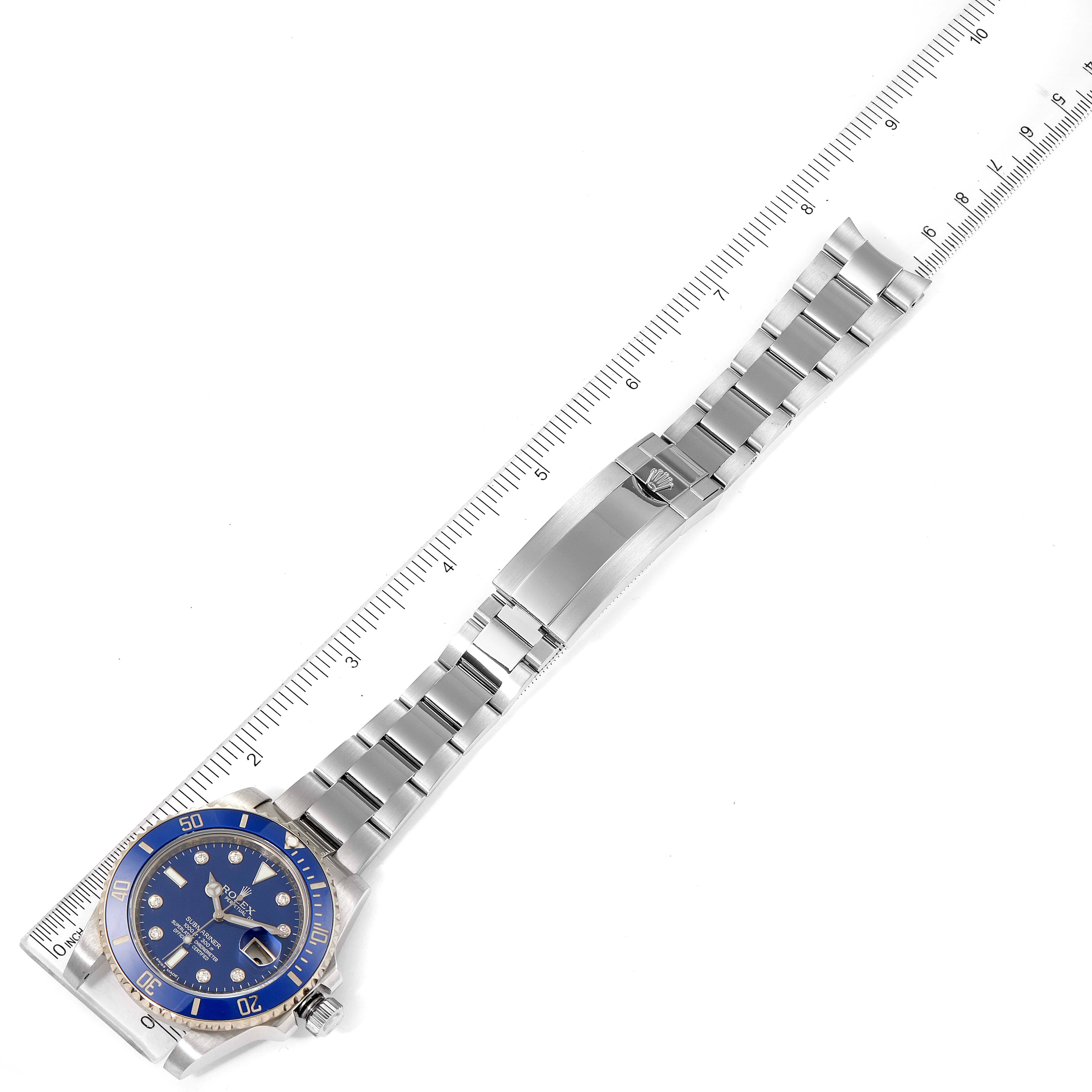 The image shows a Rolex Submariner 116619 Men's White Gold Blue Dial 116619 Men's White Gold Blue Dial watch laid flat alongside a ruler, displaying the face, bezel, and full metal bracelet.