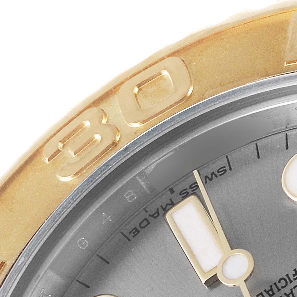 This close-up image of the Rolex Yacht-Master 168623 Men's Steel and Gold (two tone) Grey Dial 168623 Men's Steel and Gold (two tone) Grey Dial watch shows part of the bezel, dial, and hands.