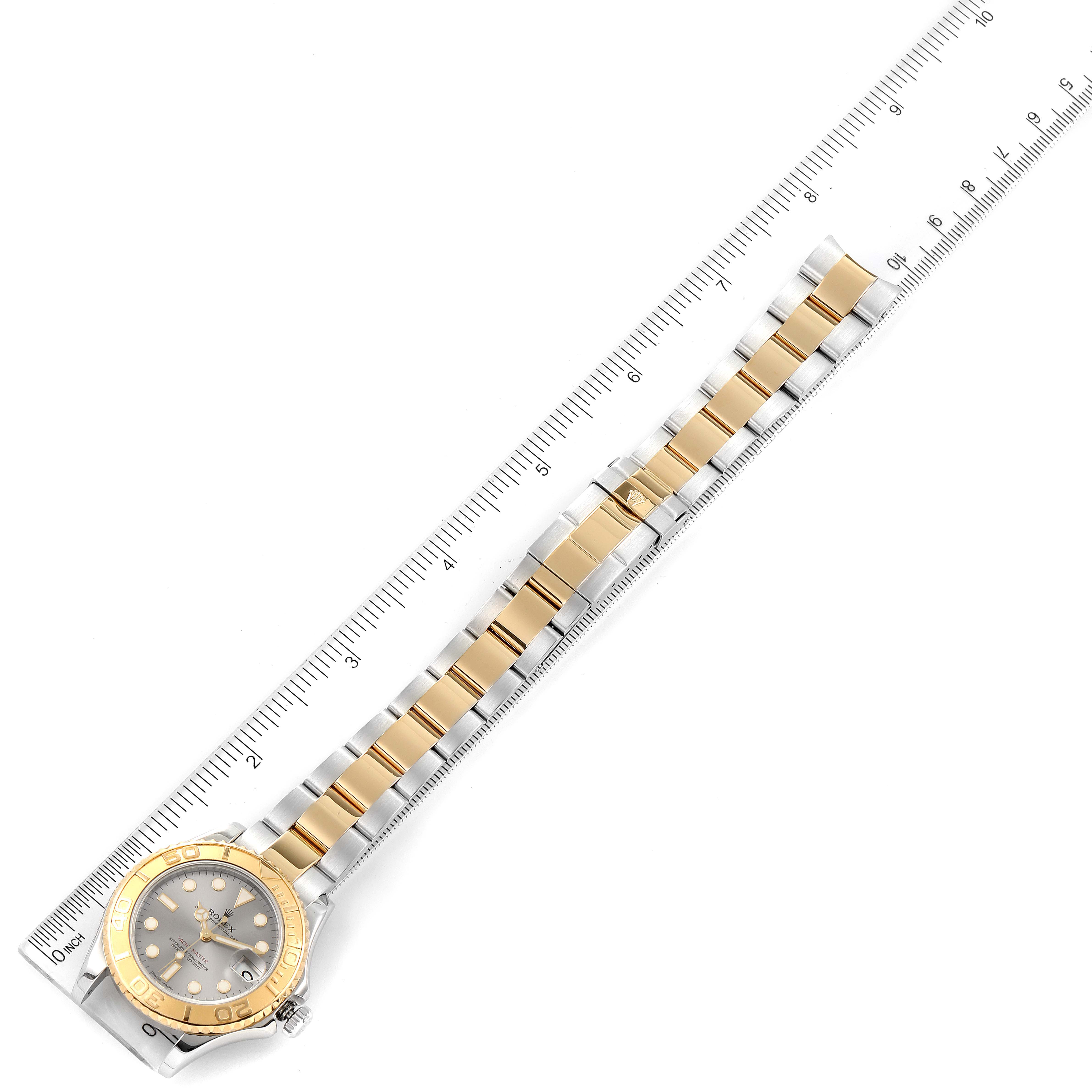 The Rolex Yacht-Master 168623 Men's Steel and Gold (two tone) Grey Dial 168623 Men's Steel and Gold (two tone) Grey Dial is shown laying flat on a measuring ruler, displaying the face and the entire band.
