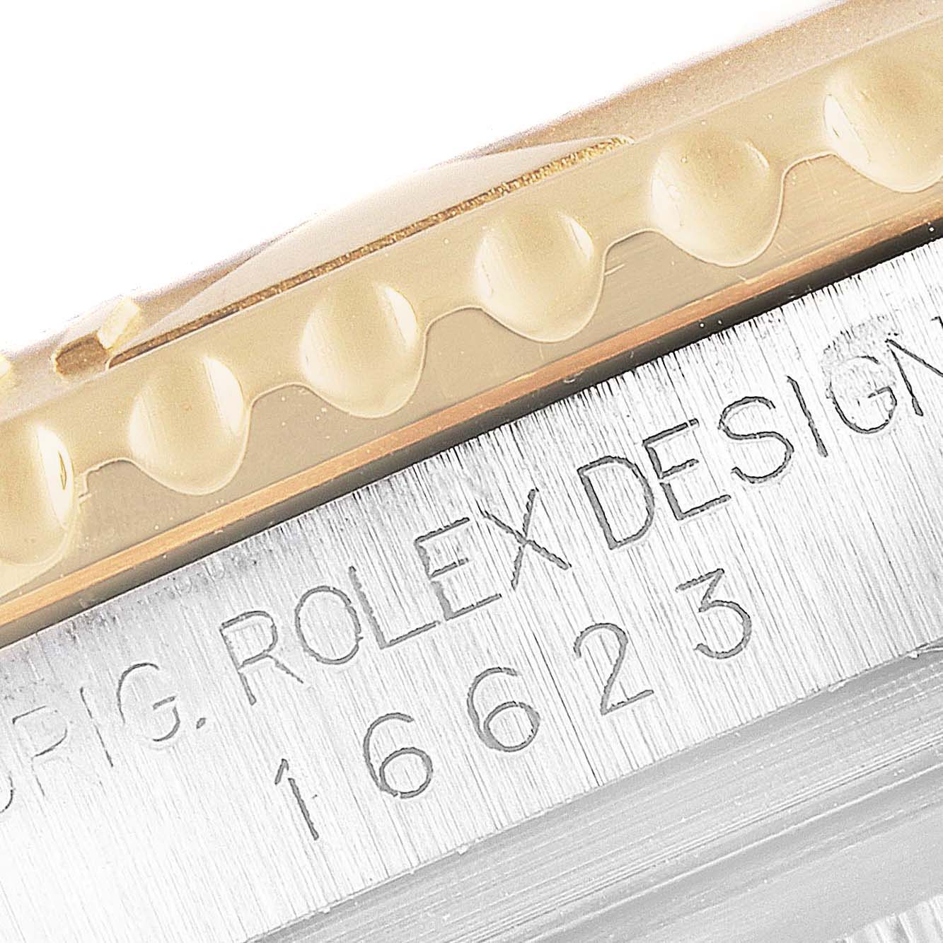 The image shows a close-up of the Rolex Yacht-Master 16623 Men's Steel and Gold (two tone) Mother of Pearl Dial 16623 Men's Steel and Gold (two tone) Mother of Pearl Dial model's bezel and the engraved "ROLEX DESIGN" on the case side.
