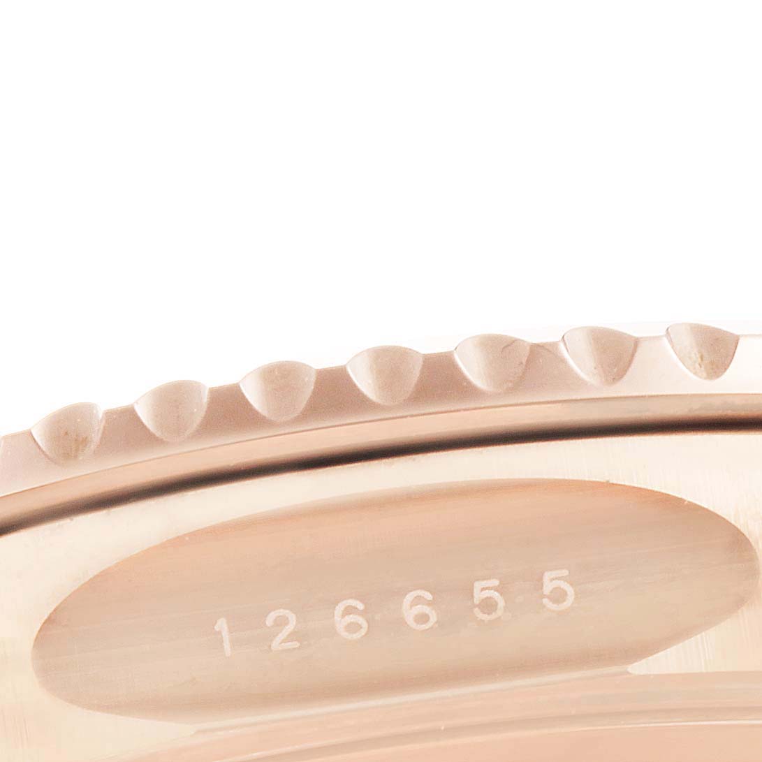 The image shows a close-up of the Rolex Yacht-Master 126655 Men's Rose Gold Black Dial 126655 Men's Rose Gold Black Dial watch bezel and part of the serial number engraved on the inner case.