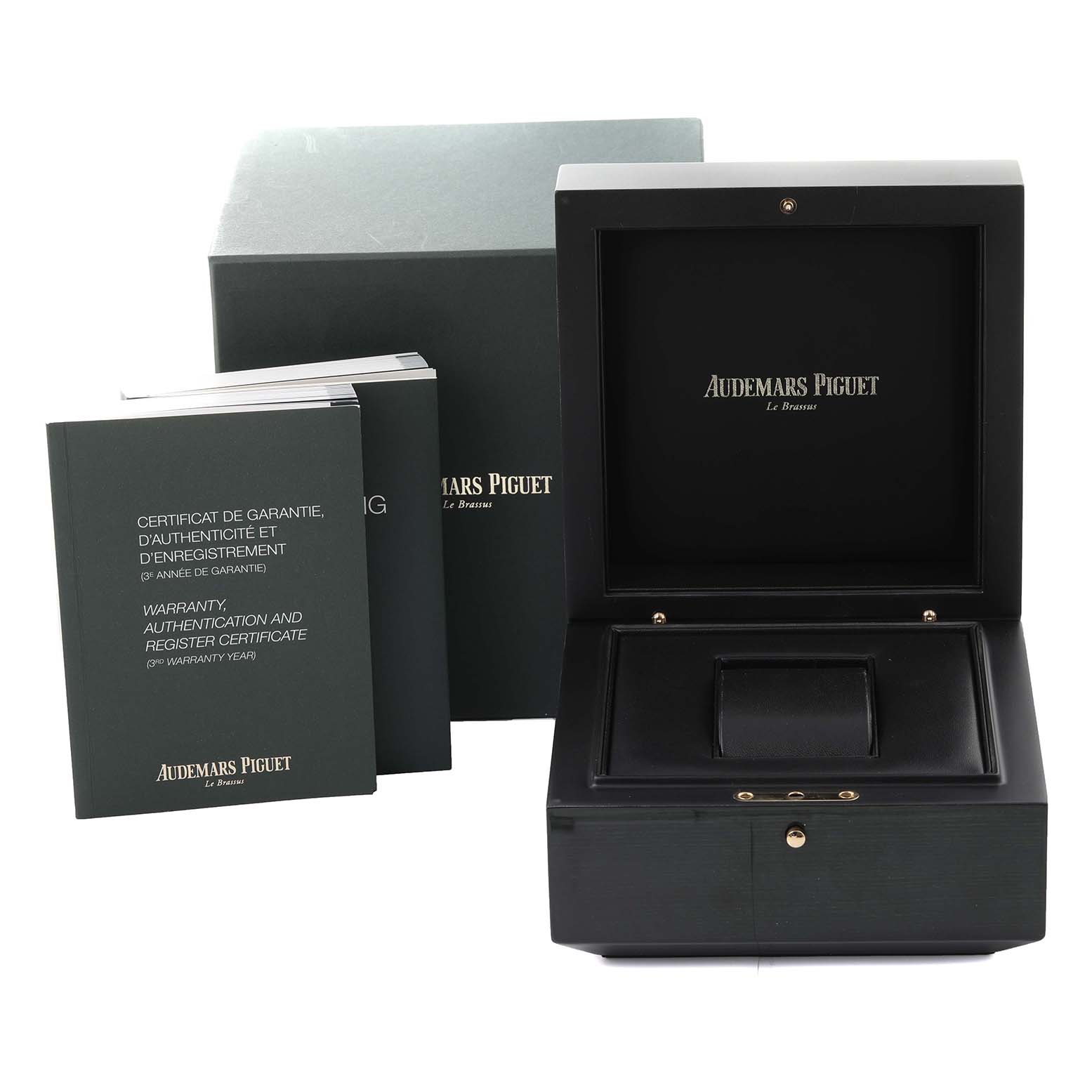 The image shows the packaging accessories of an Audemars Piguet Royal Oak 26320OR.OO.D002CR.01 Men's Rose Gold Black Dial 26320OR.OO.D002CR.01 Men's Rose Gold Black Dial model, including a watch box and documentation.