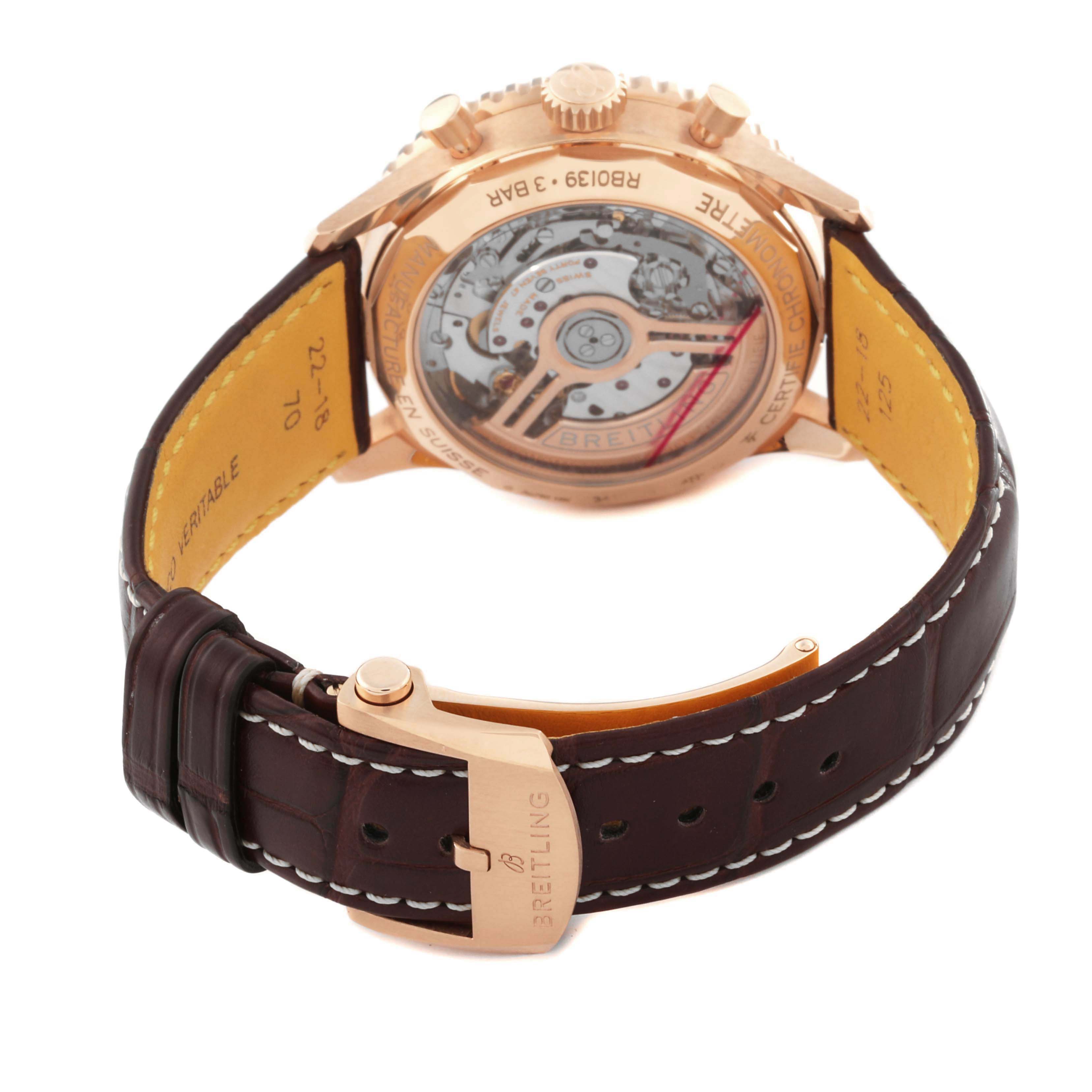 The image shows the back view of a Breitling Navitimer RB0139 Men's Rose Gold Silver Dial RB0139 Men's Rose Gold Silver Dial watch, focusing on the transparent case back and the strap buckle.