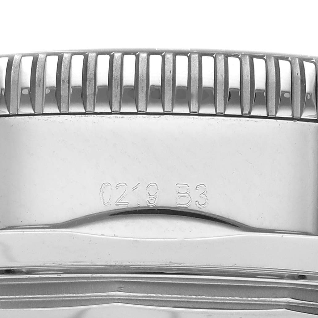 This close-up image of the Breitling Superocean AB2030 Men's Stainless Steel Blue Dial AB2030 Men's Stainless Steel Blue Dial watch shows the side view of the bezel and part of the case with engraved markings.