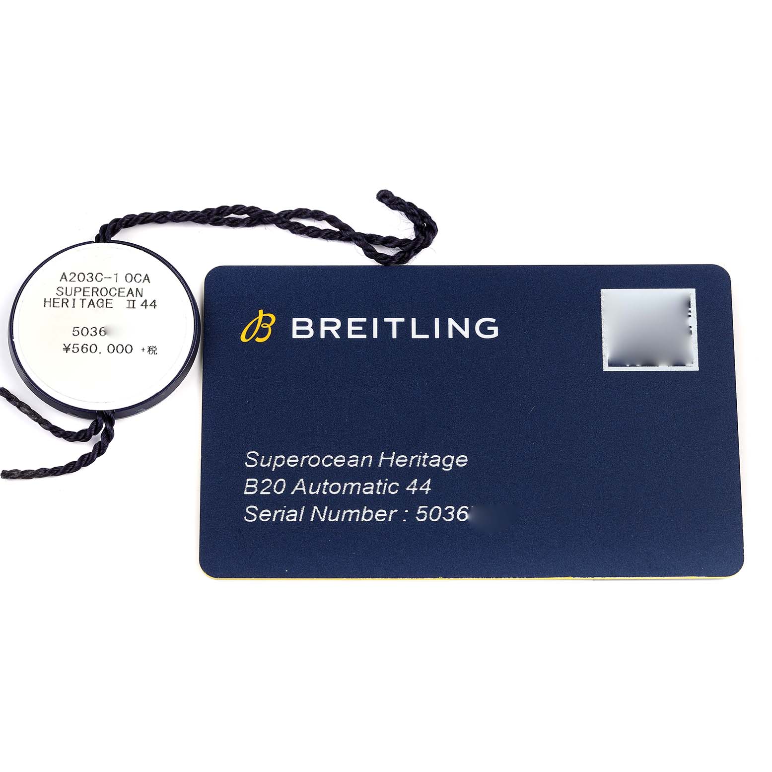 The image shows the accessory tags for the Breitling Superocean AB2030 Men's Stainless Steel Blue Dial AB2030 Men's Stainless Steel Blue Dial Heritage B20 Automatic 44 watch, including its serial number and model information.