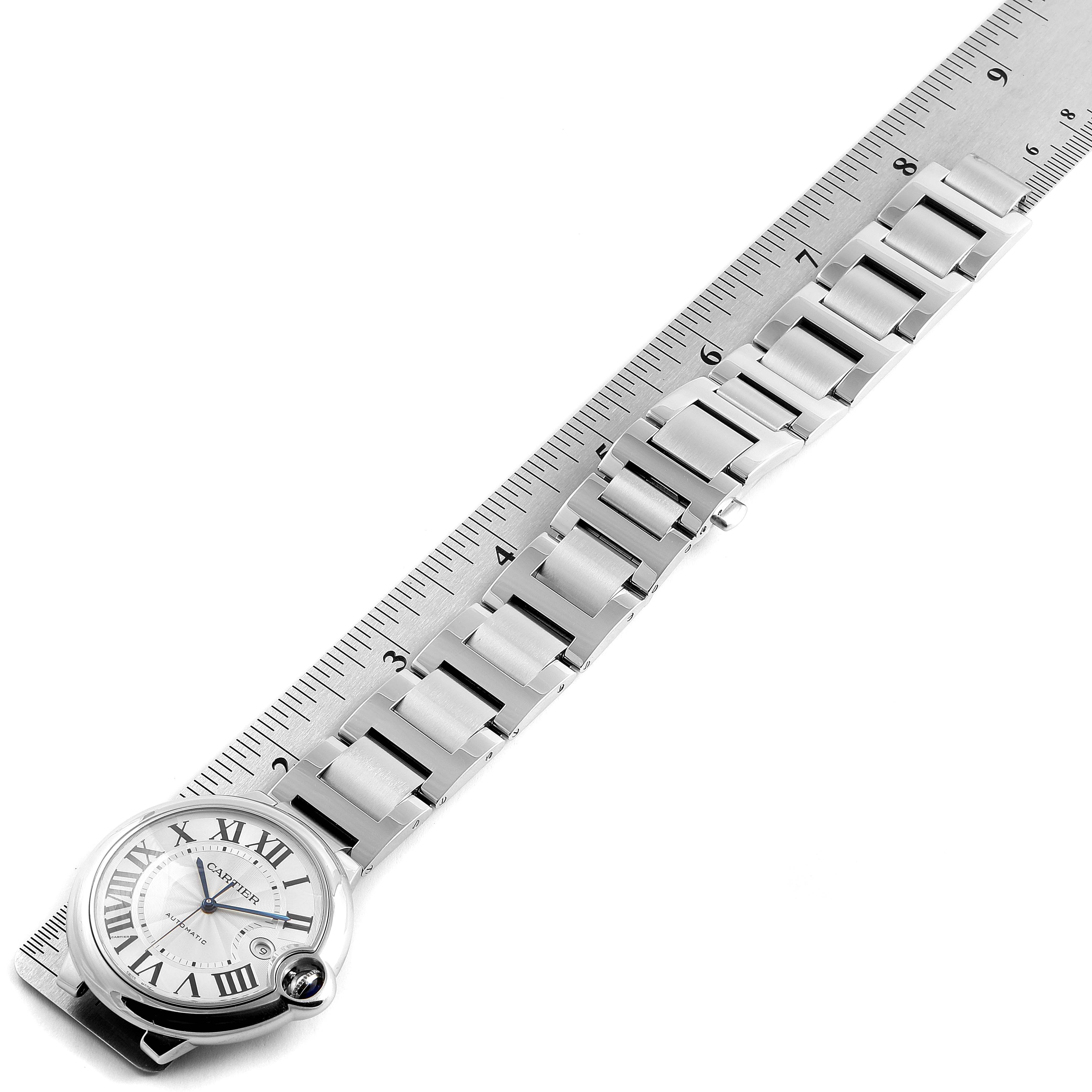 The image shows a Cartier Ballon Bleu W69012Z4 Men's Stainless Steel Silver Dial W69012Z4 Men's Stainless Steel Silver Dial watch laid out flat alongside a ruler.