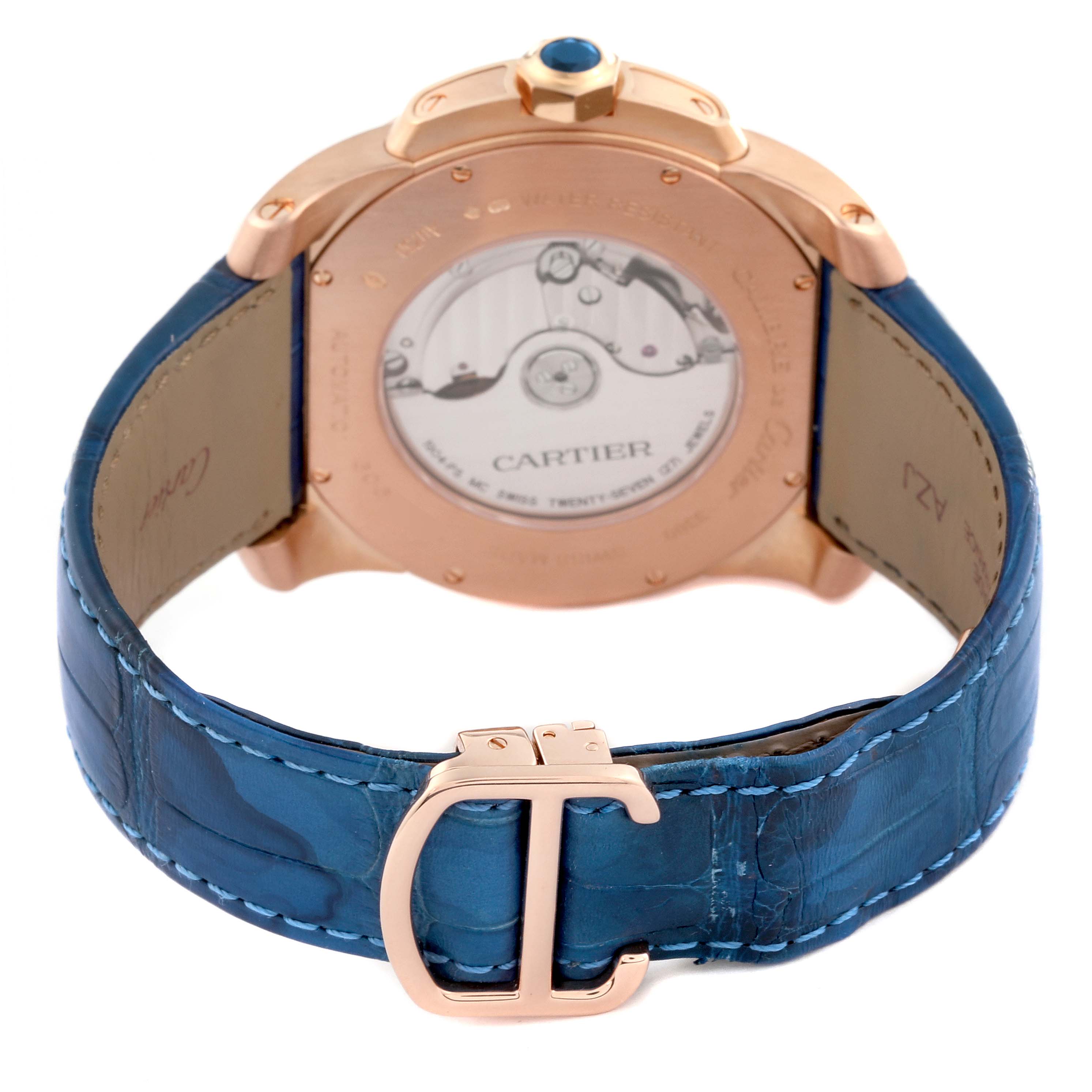 The image shows the back view of the Calibre de Cartier watch by Cartier, highlighting the case back and blue leather strap with the brand's clasp.