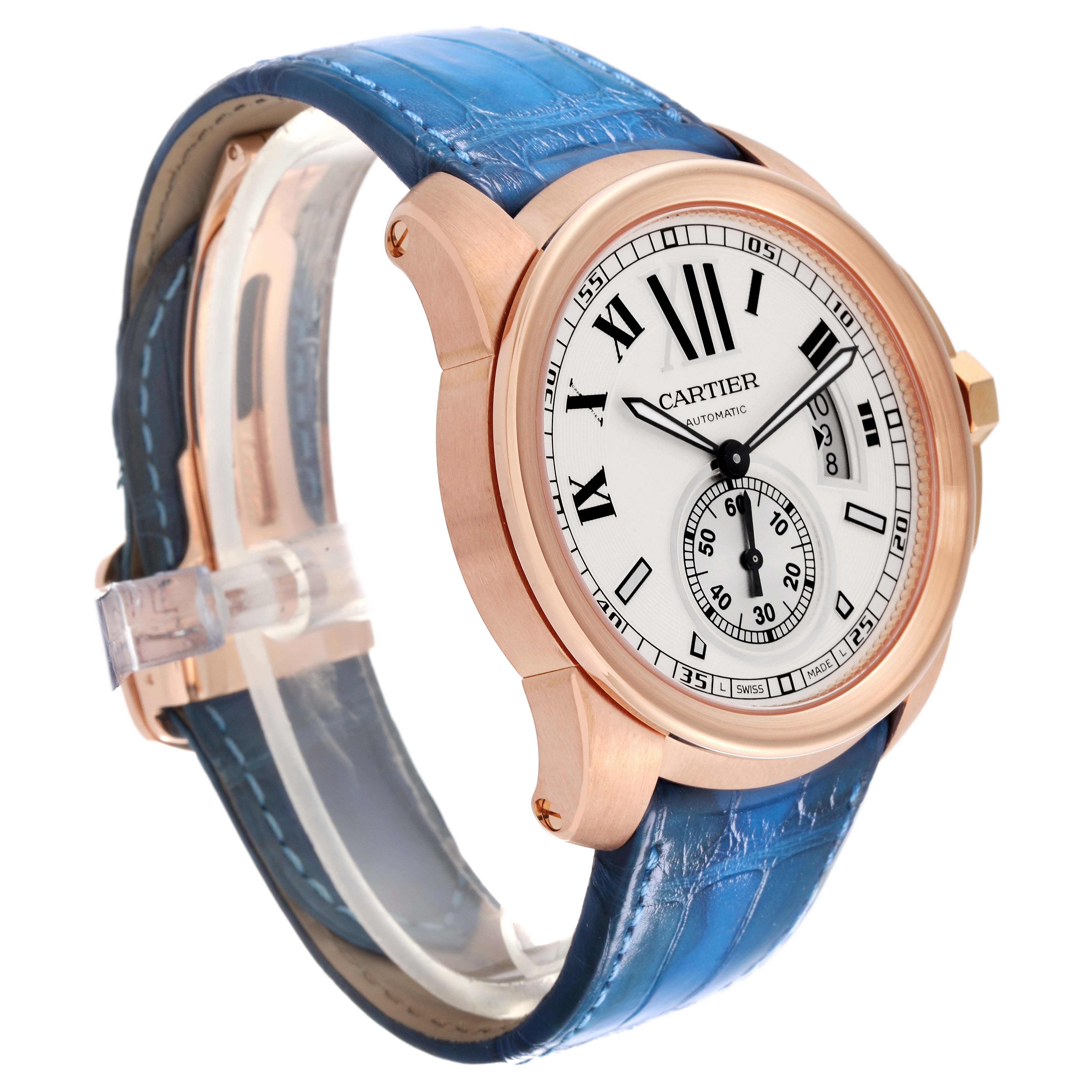 The image shows a Calibre de Cartier watch by Cartier from a 3/4 side angle highlighting the face, bezel, and blue leather strap.