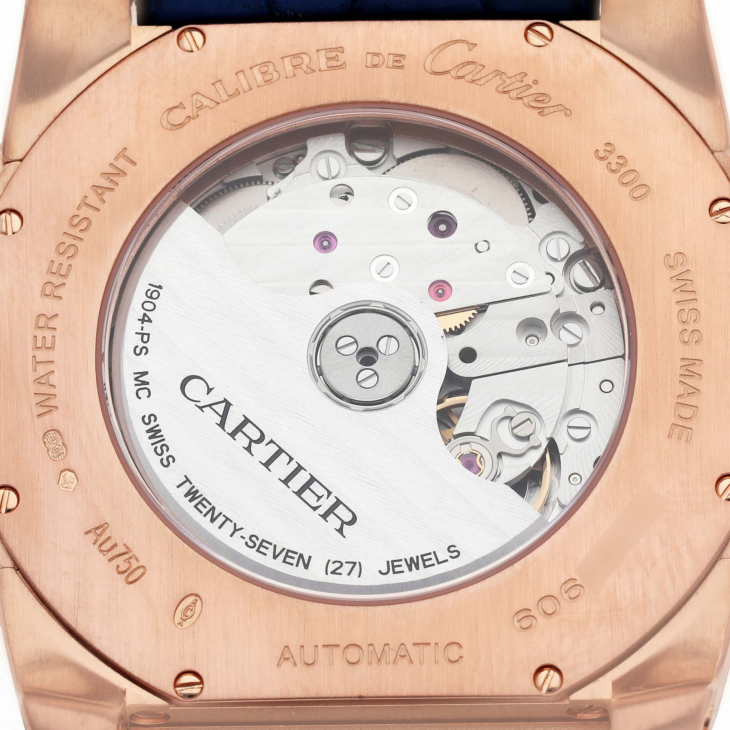 The image shows the back of a Calibre de Cartier watch by Cartier, revealing its automatic movement and inner mechanisms.