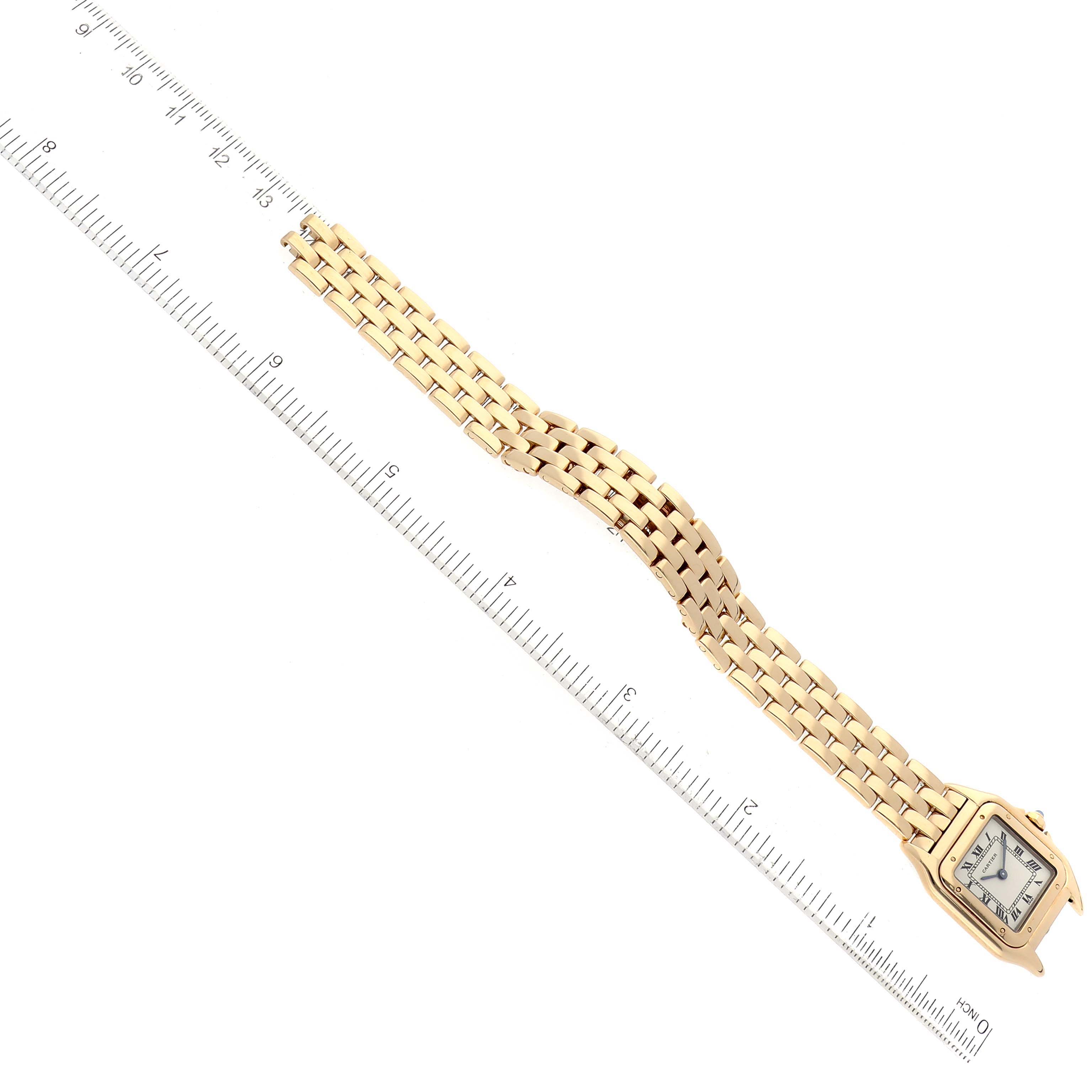 The image shows an overhead view of the Cartier Panthere W25022B9 Women's Yellow Gold Silver Dial W25022B9 Women's Yellow Gold Silver Dial watch, with a ruler for scale, displaying the entire bracelet and watch face.