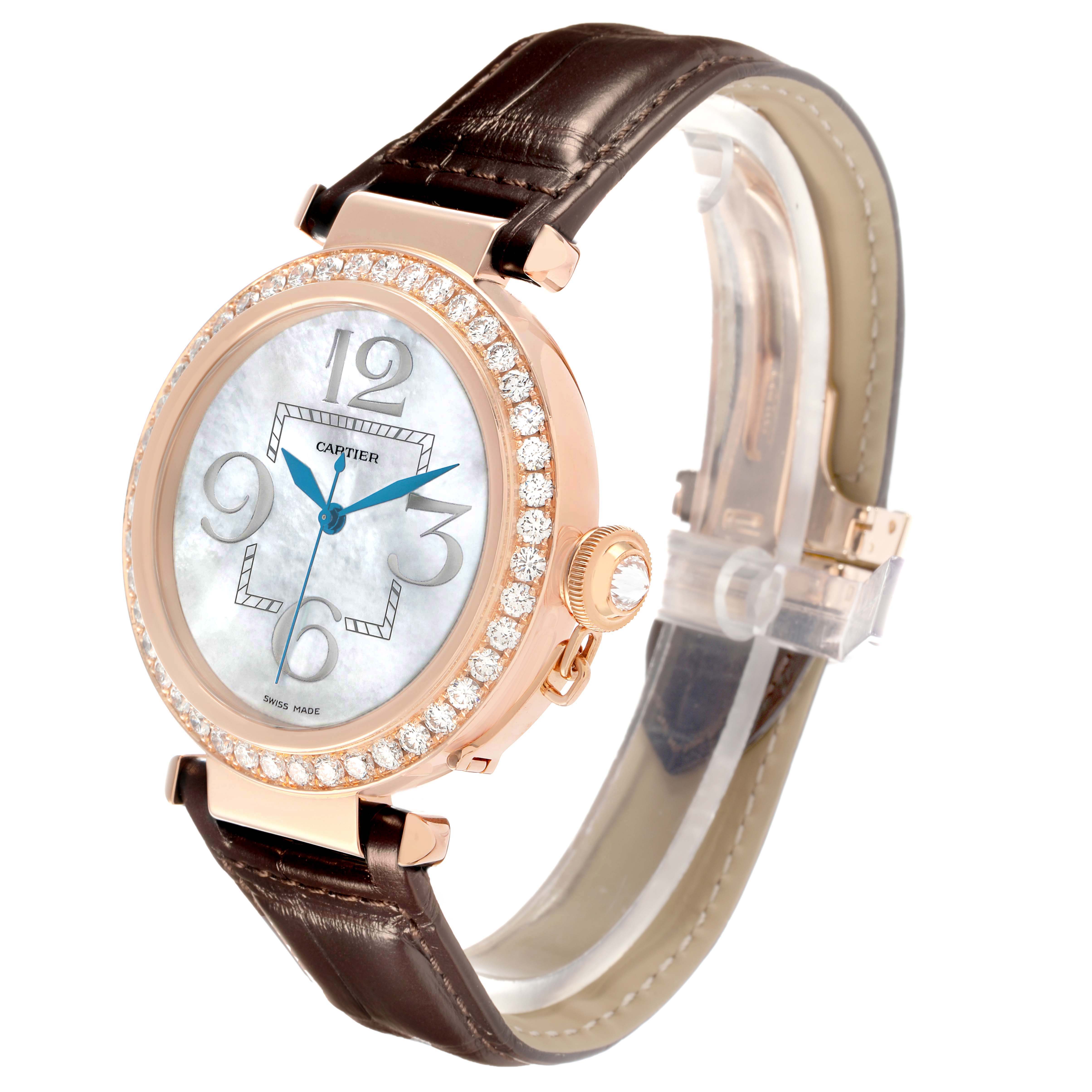 The Cartier Pasha WJ124005 Women
s Rose Gold Mother of Pearl Dial watch is shown at a three-quarter angle, highlighting the diamond bezel, crown, and leather strap.