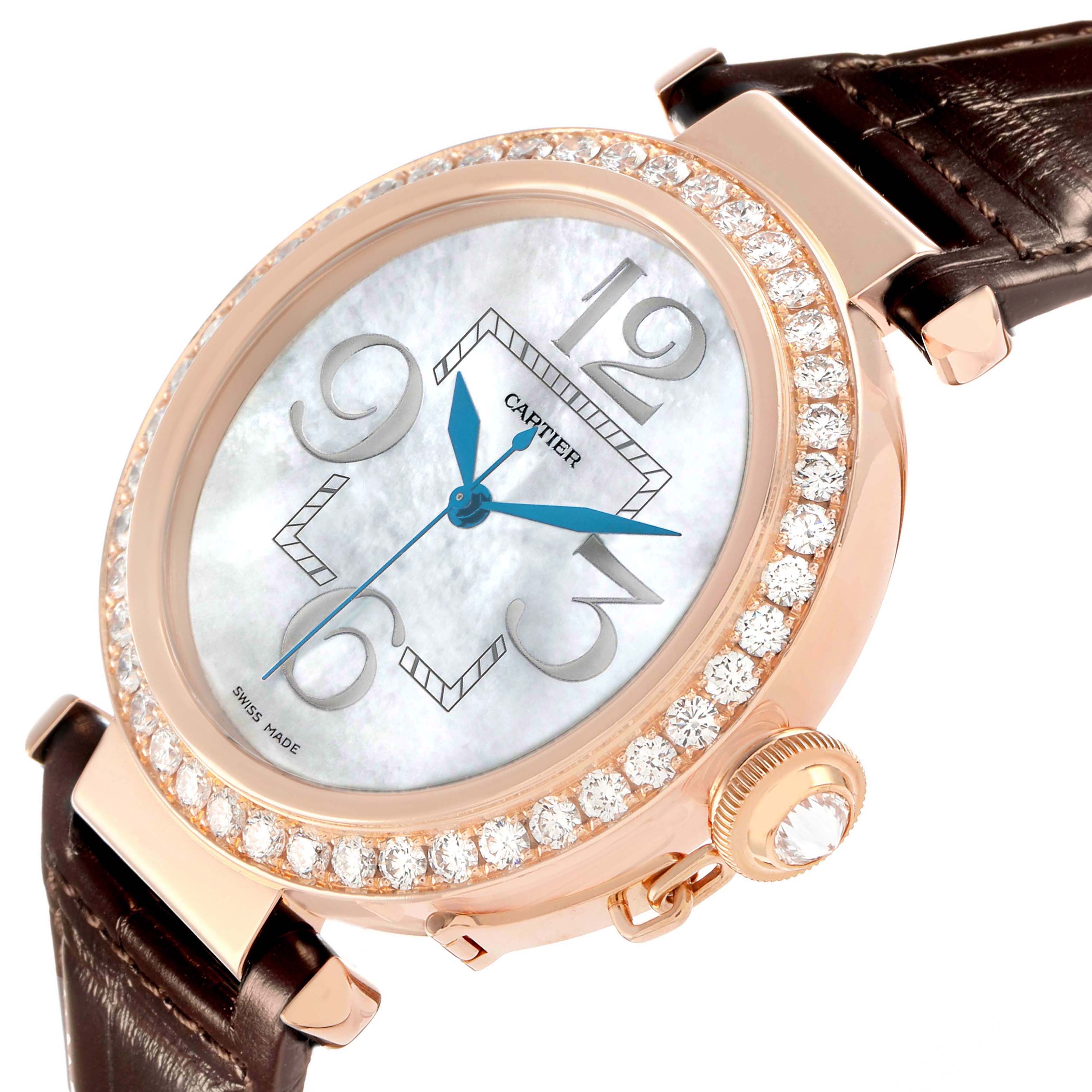The Cartier Pasha WJ124005 Women
s Rose Gold Mother of Pearl Dial watch is shown at an angled close-up, highlighting the diamond-encrusted bezel and the crown detail with a leather strap.
