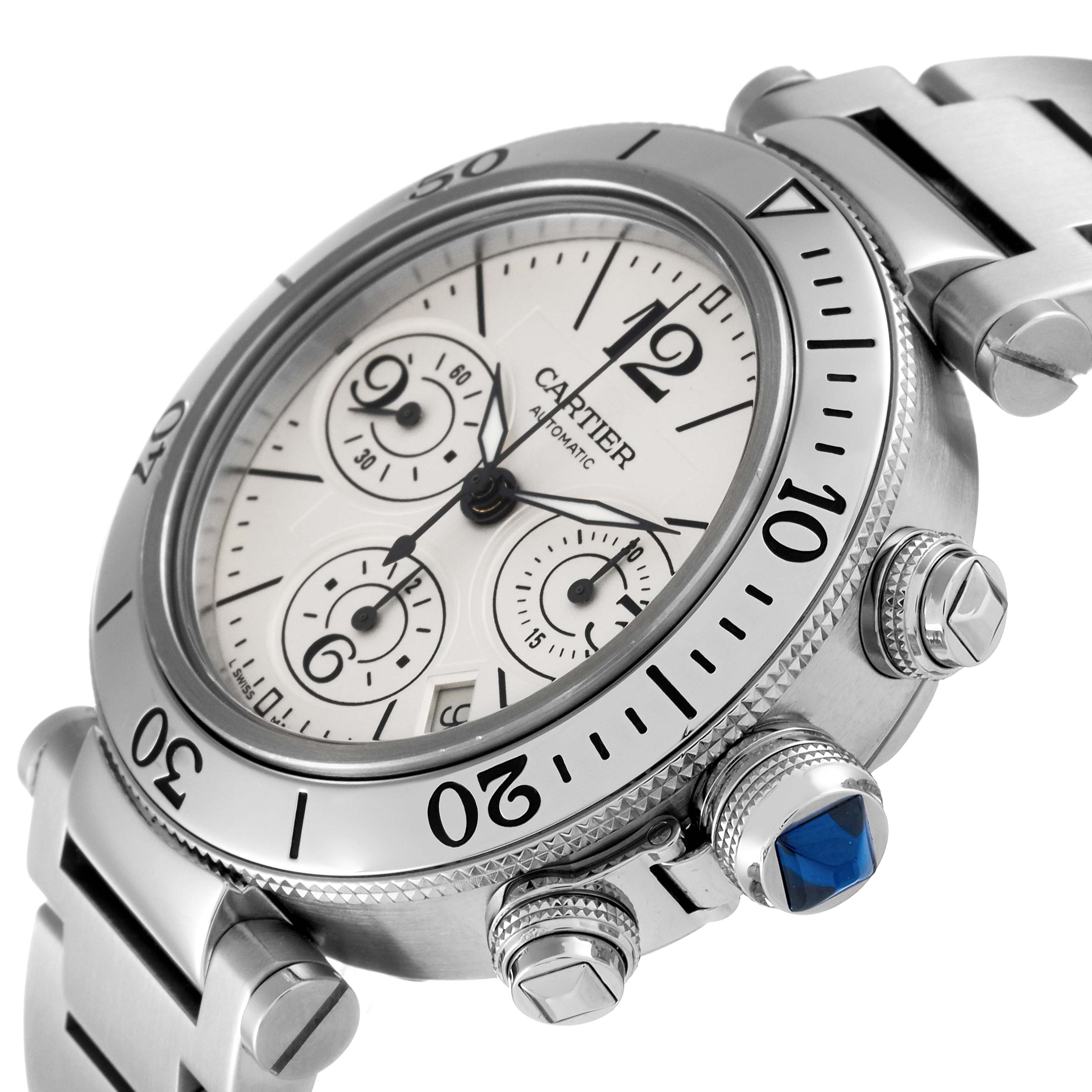 The image shows a close-up angle of the Cartier Pasha W31089M7 Men's Stainless Steel Silver Dial W31089M7 Men's Stainless Steel Silver Dial watch, highlighting its dial, bezel, pushers, and a blue cabochon crown.