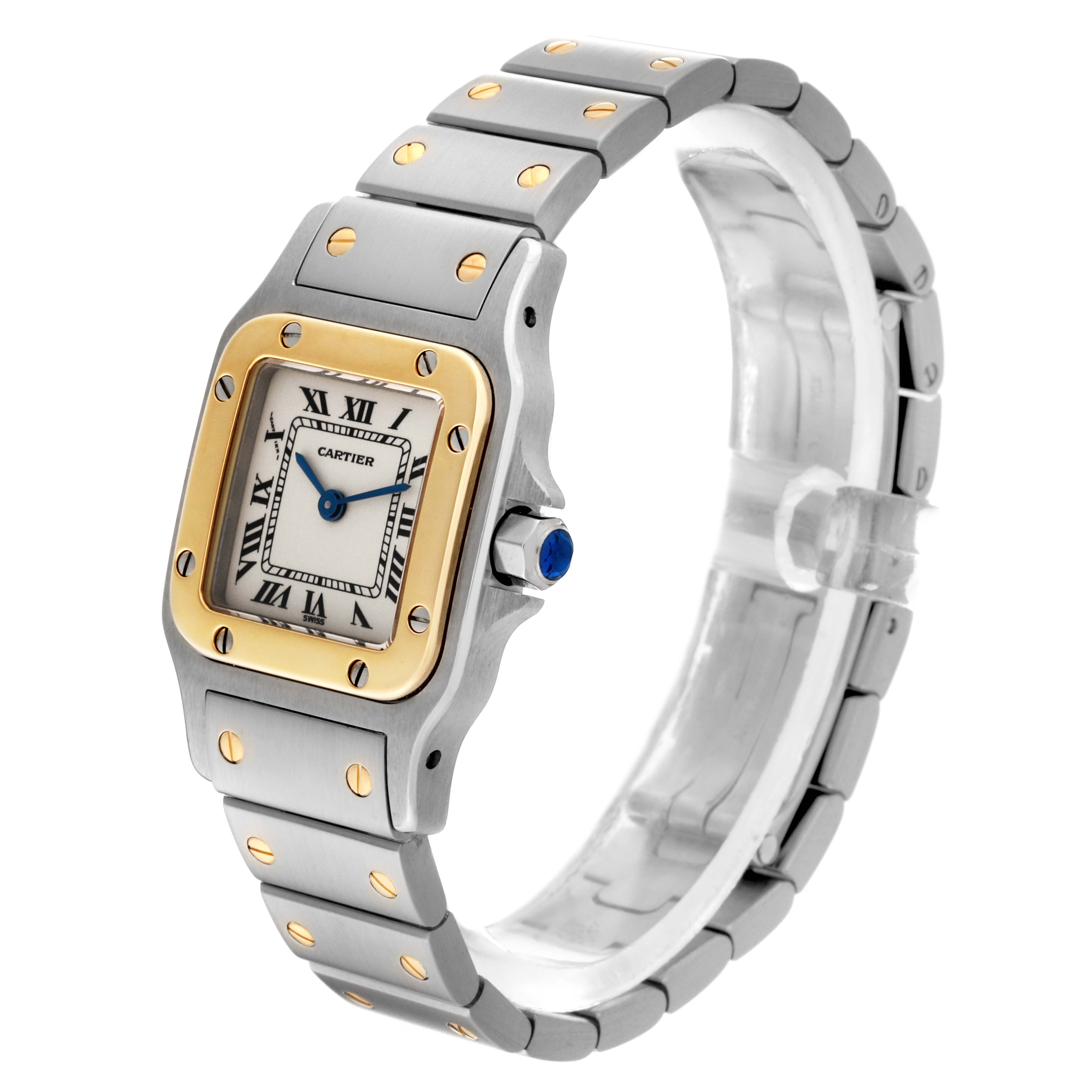This image shows a side angle view of the Cartier Santos W20012C4 Women's Steel and Gold (two tone) Silver Dial W20012C4 Women's Steel and Gold (two tone) Silver Dial watch, displaying its square dial, bracelet, and visible screws.