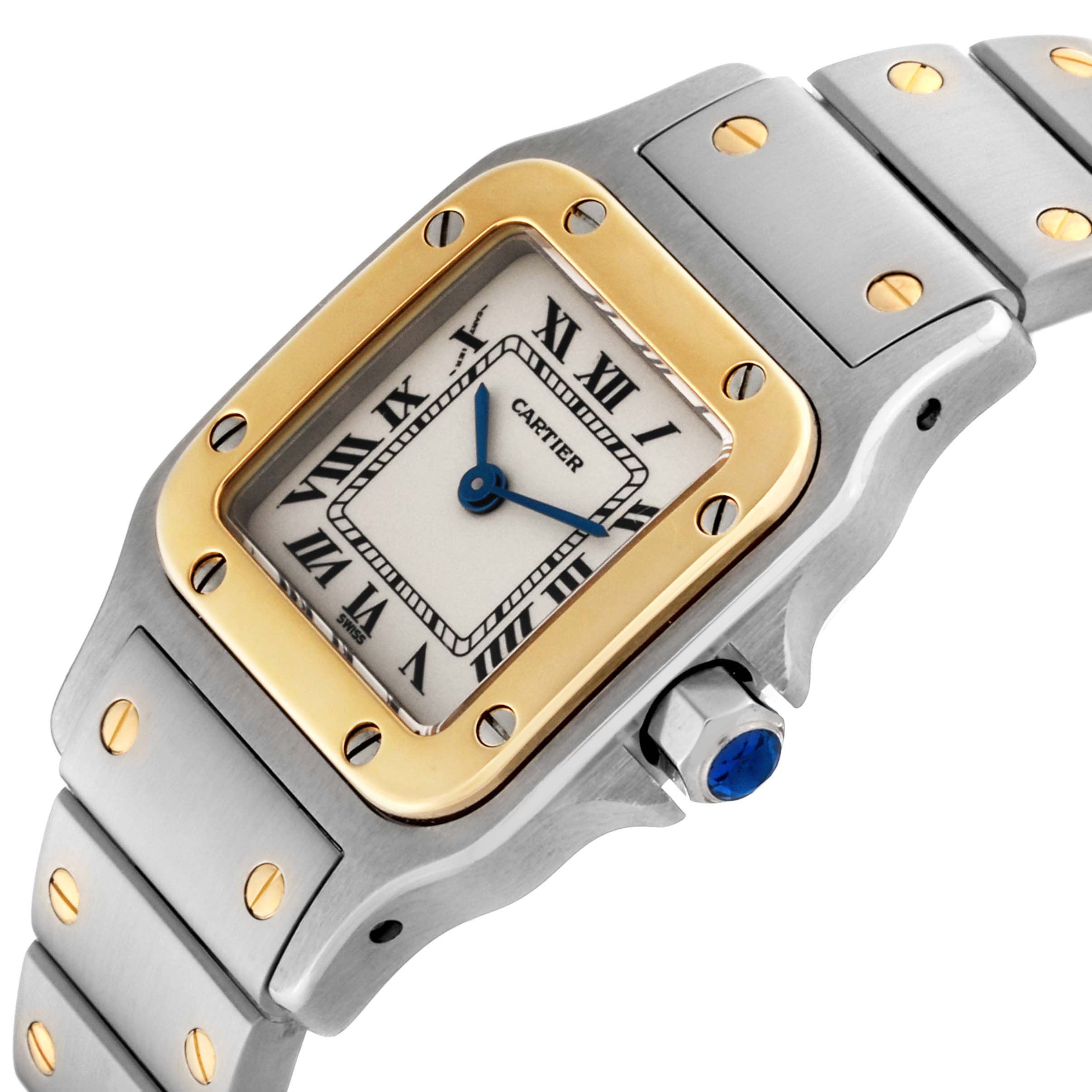 The image shows a Cartier Santos W20012C4 Women's Steel and Gold (two tone) Silver Dial W20012C4 Women's Steel and Gold (two tone) Silver Dial model watch at an angled view, highlighting its dial, bezel, crown, and part of the bracelet.