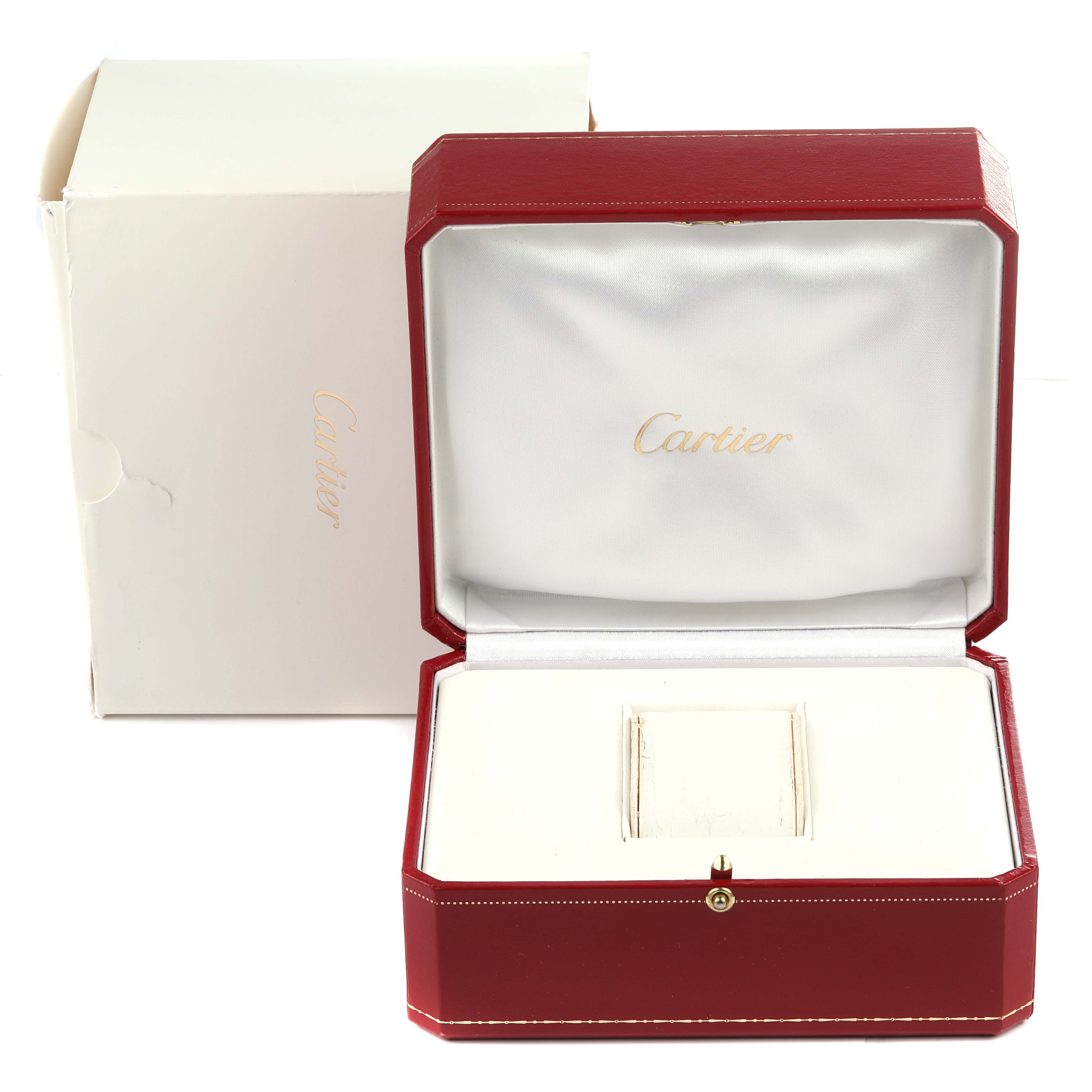 The image shows the open box for a Santos model by Cartier, featuring the inner compartment and outer packaging.
