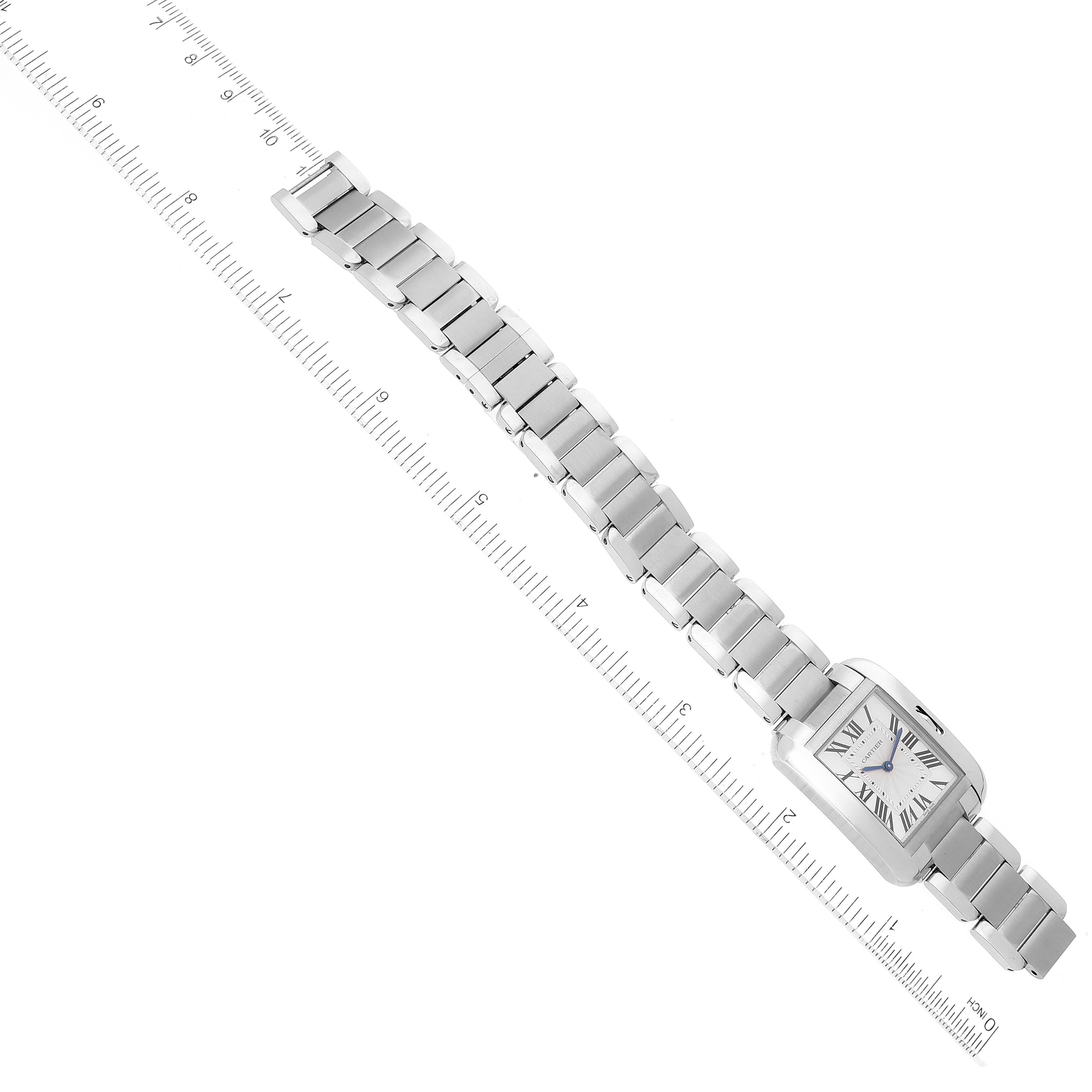 The image shows the Cartier Tank Anglaise W5310044 Women's Stainless Steel Silver Dial W5310044 Women's Stainless Steel Silver Dial watch from a top-down angle, displaying the face and full metal band alongside a ruler for scale.