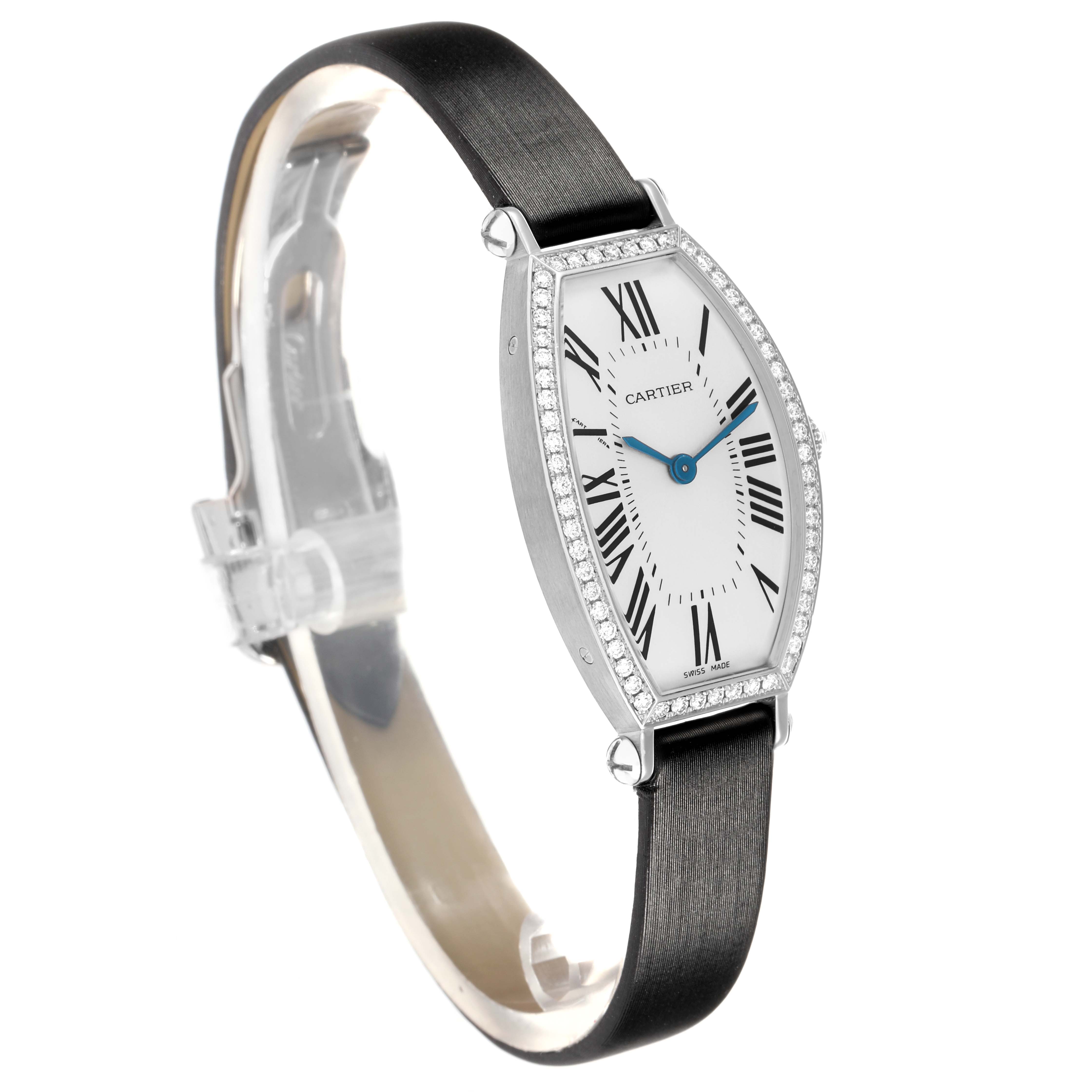 The Cartier Tonneau WE400131 Women
s White Gold Silver Dial watch is shown at a side angle, displaying its case, dial, strap, and diamond bezel.