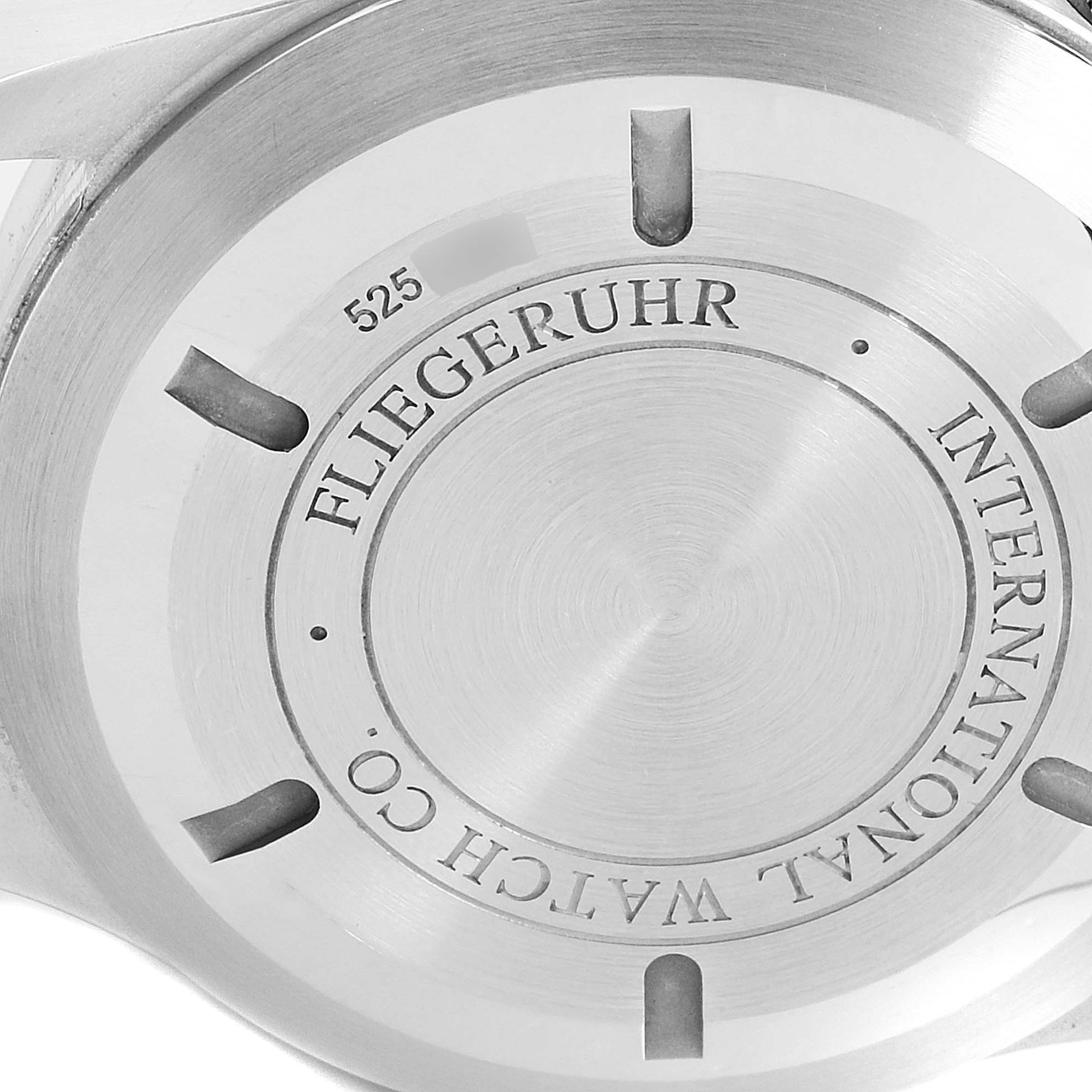 The image shows the back case of an IWC Pilot IW377704 Men's Stainless Steel Black Dial IW377704 Men's Stainless Steel Black Dial model watch, featuring brand engravings and a brushed metal finish.