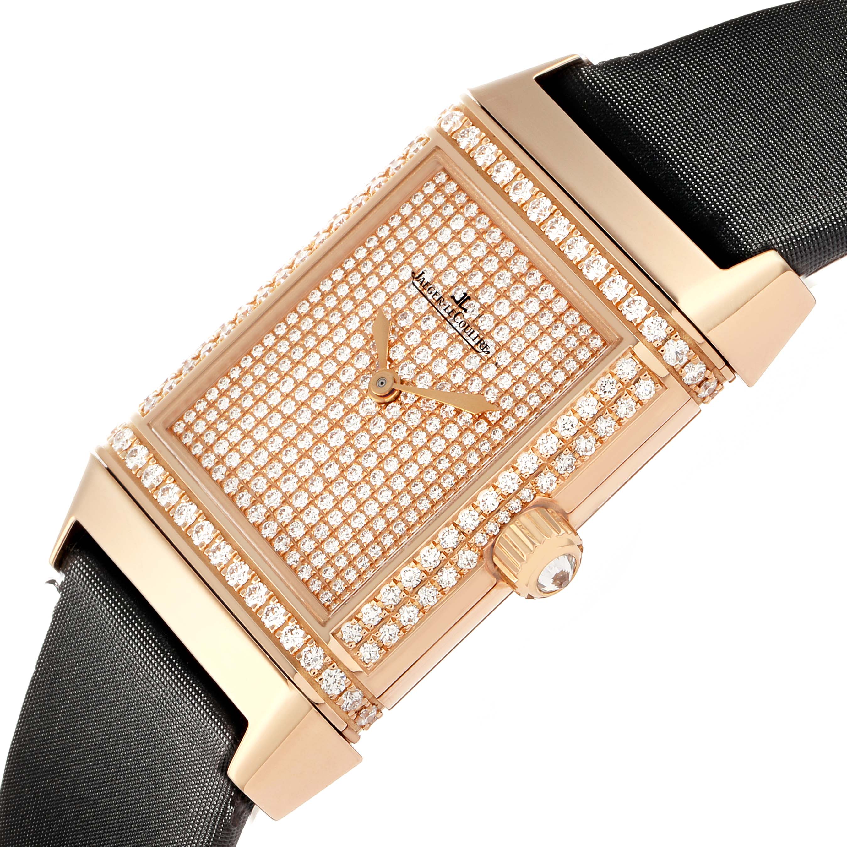 The Jaeger-LeCoultre Reverso watch is shown at an angled top view, highlighting its diamond-encrusted case and dial, with a visible crown.