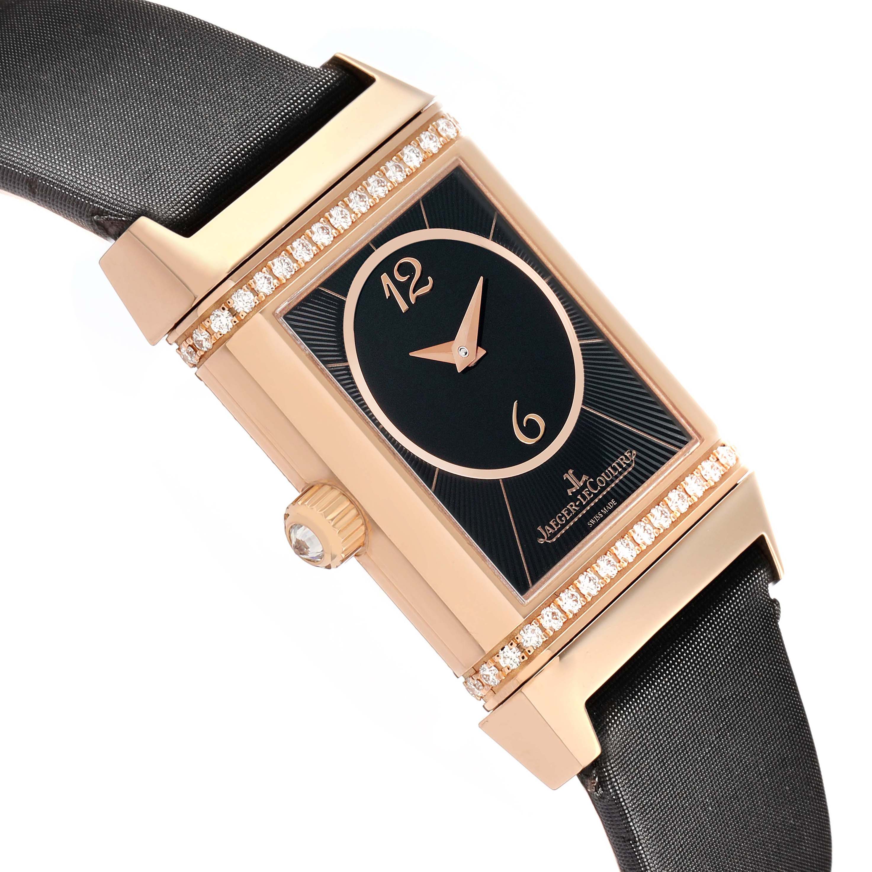 The Jaeger LeCoultre Reverso Q2562407 Women
s Rose Gold Pink Dial watch is angled to show its side and face, highlighting its crown and diamond-set case.