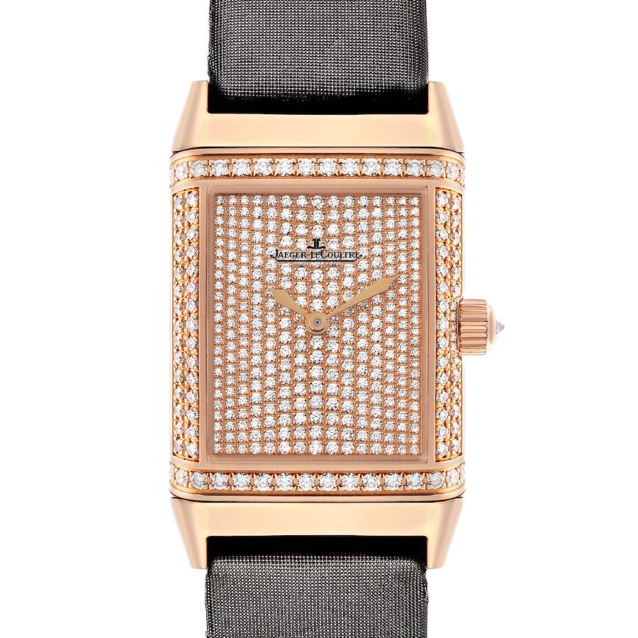 The Jaeger-LeCoultre Reverso watch is shown from the front, highlighting its diamond-studded face and gold case.