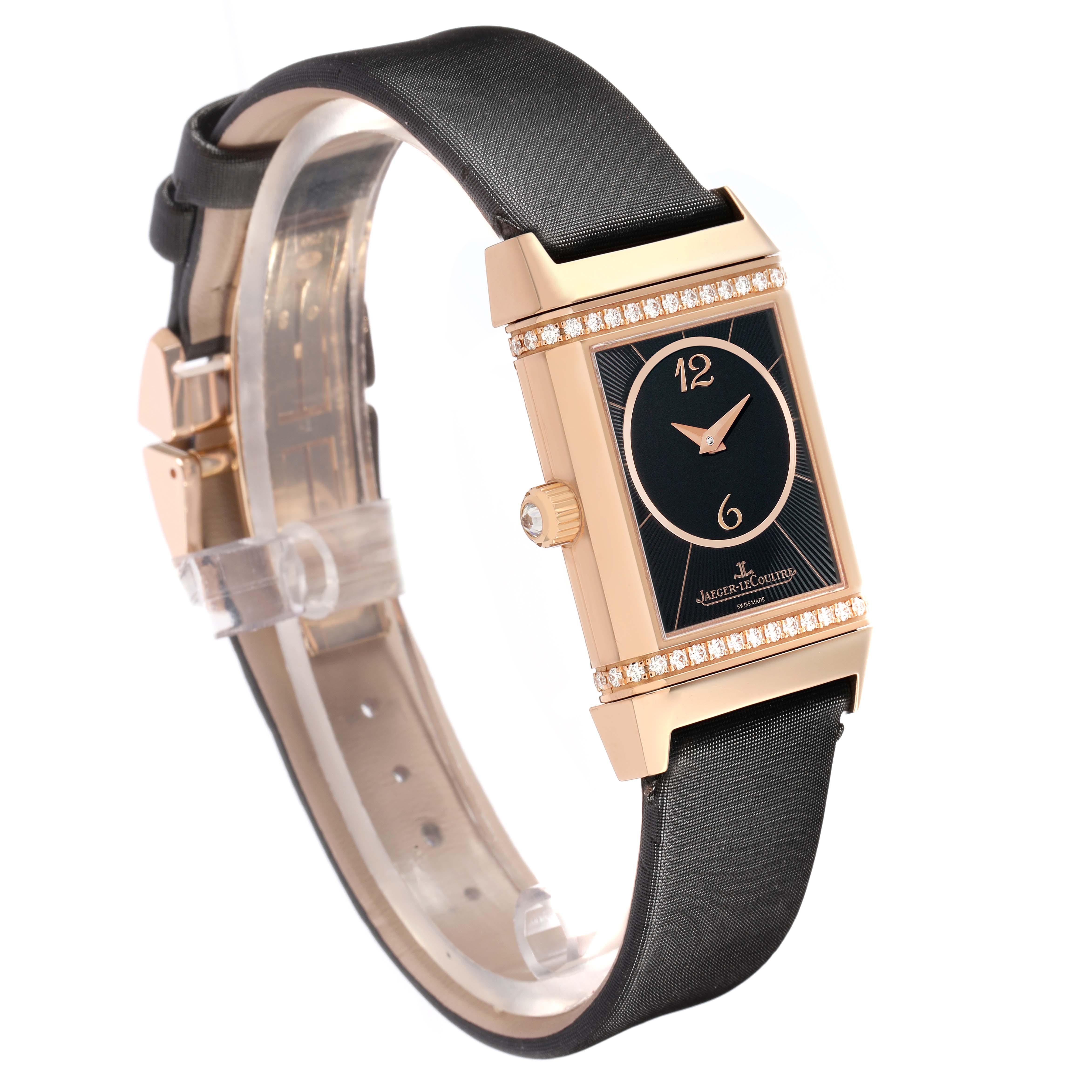 The Jaeger-LeCoultre Reverso watch is shown at a three-quarter angle, highlighting its rectangular face, side crown, and strap.