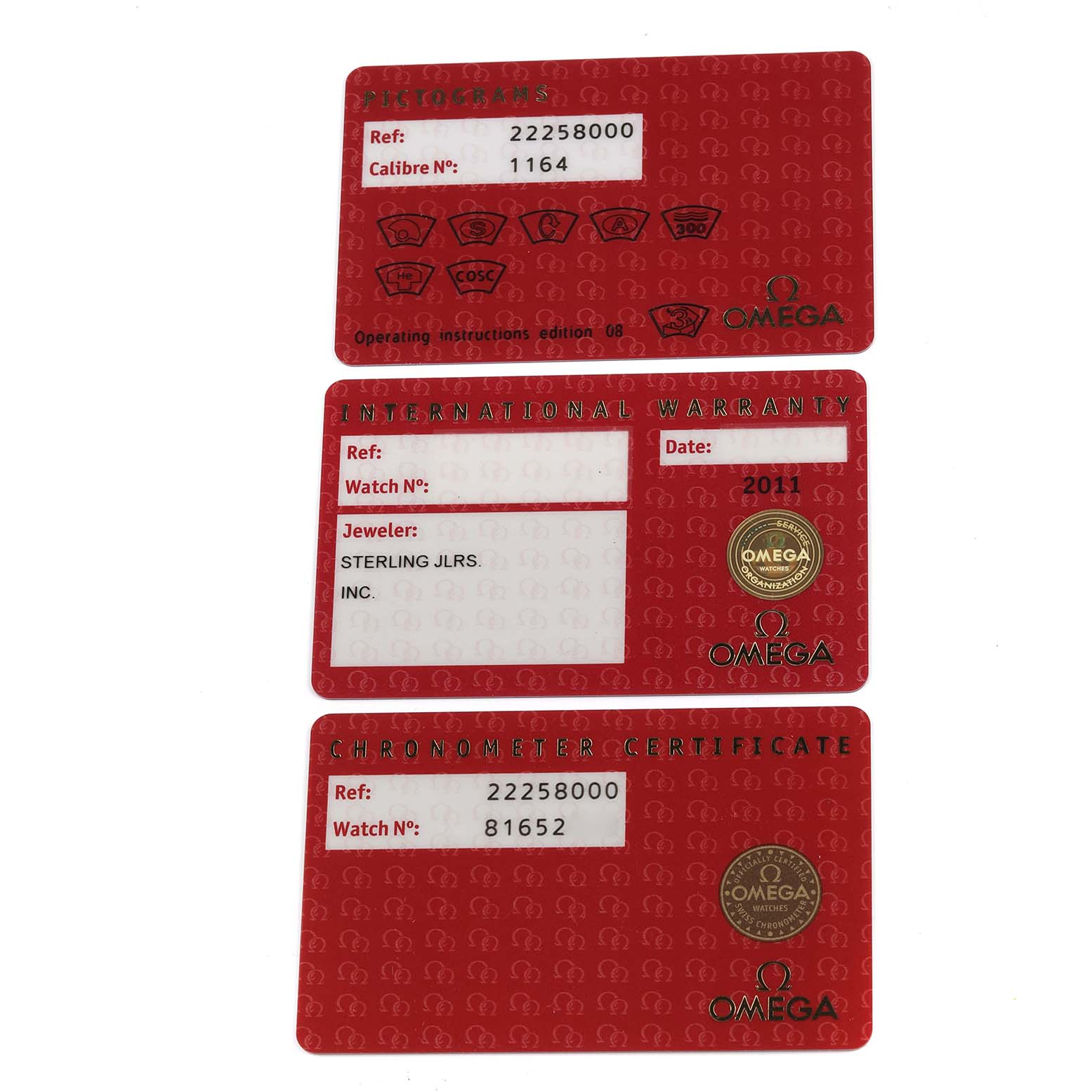 The image shows three red Omega Seamaster 2225.80.00 Men
s Stainless Steel Blue Dial 2225.80.00 Men
s Stainless Steel Blue Dial accessory cards: pictograms, international warranty, and chronometer certificate.