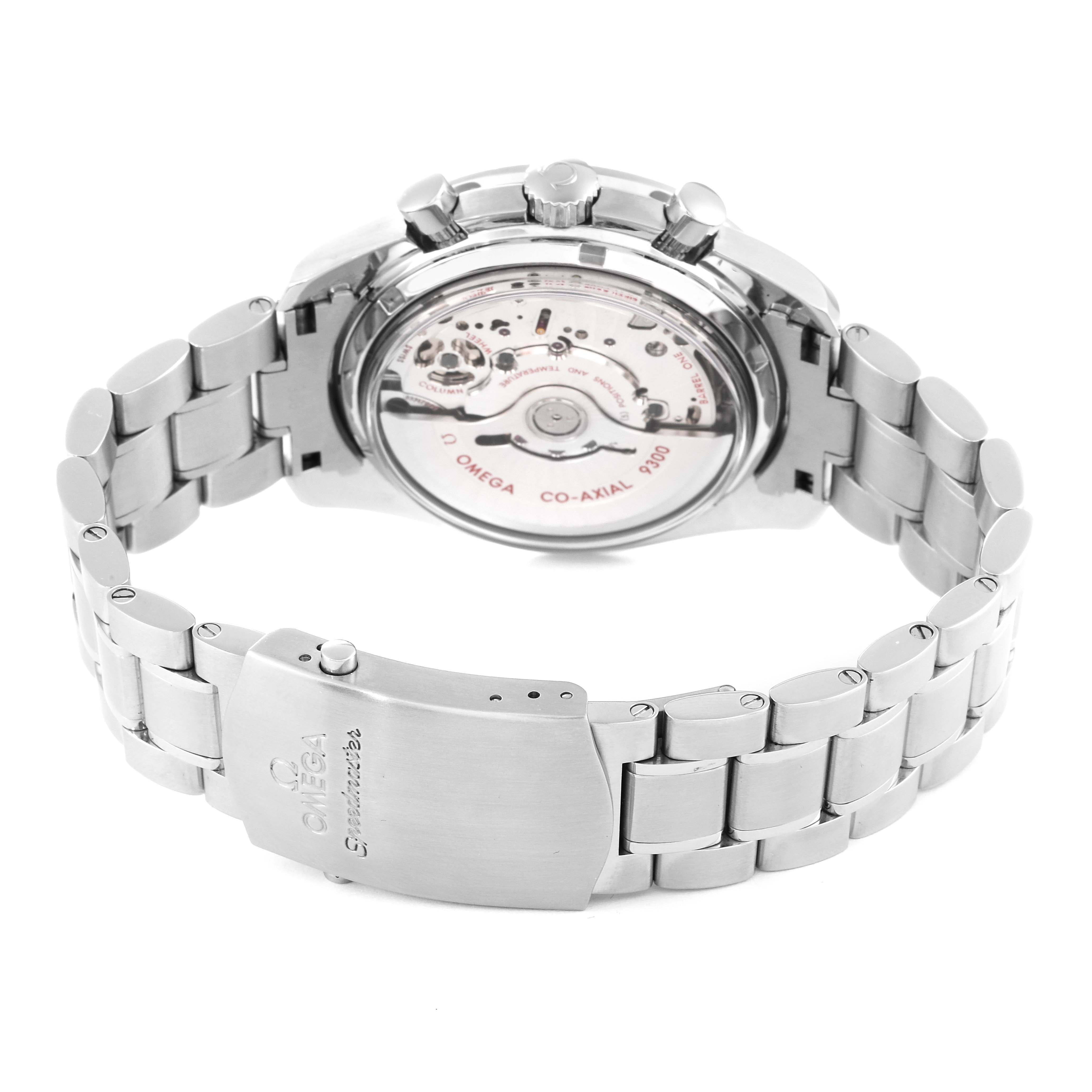 The image shows the back view of an Omega Speedmaster 311.30.44.51.01.002 Men
s Stainless Steel Black Dial 311.30.44.51.01.002 Men
s Stainless Steel Black Dial watch, highlighting its exposed co-axial 9300 movement and stainless steel bracelet.