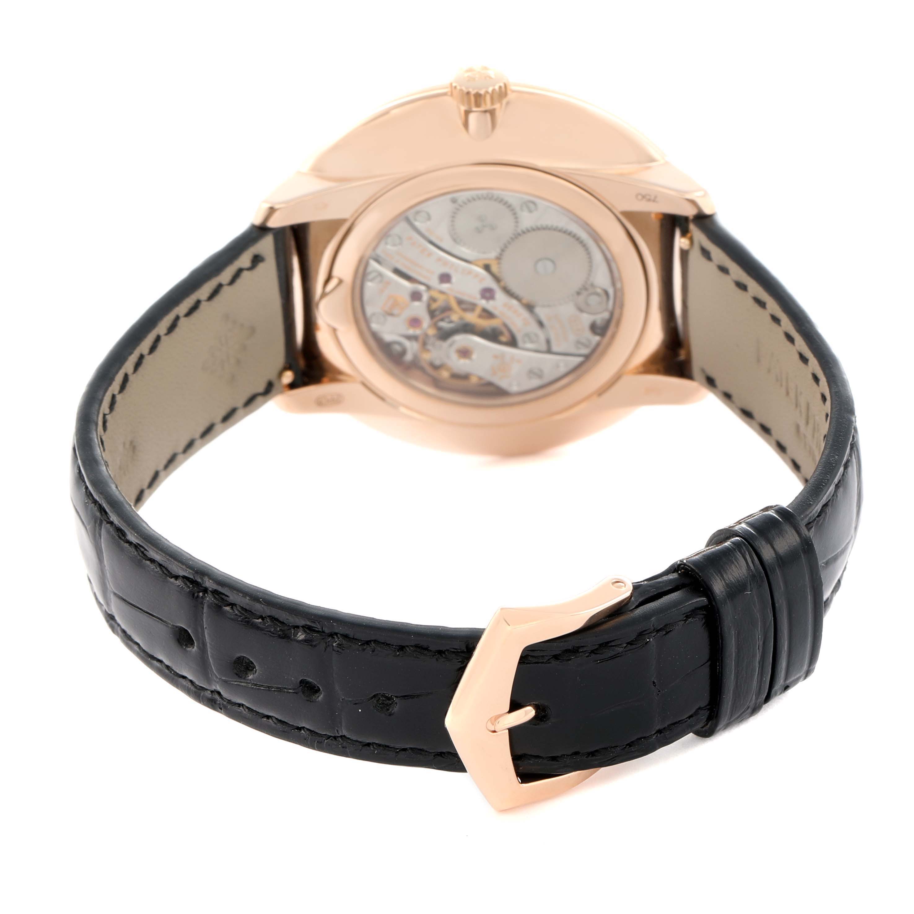 The image shows the back view of a Patek Philippe Calatrava 5123R Men
s Rose Gold Silver Dial, highlighting its transparent case back and leather strap.