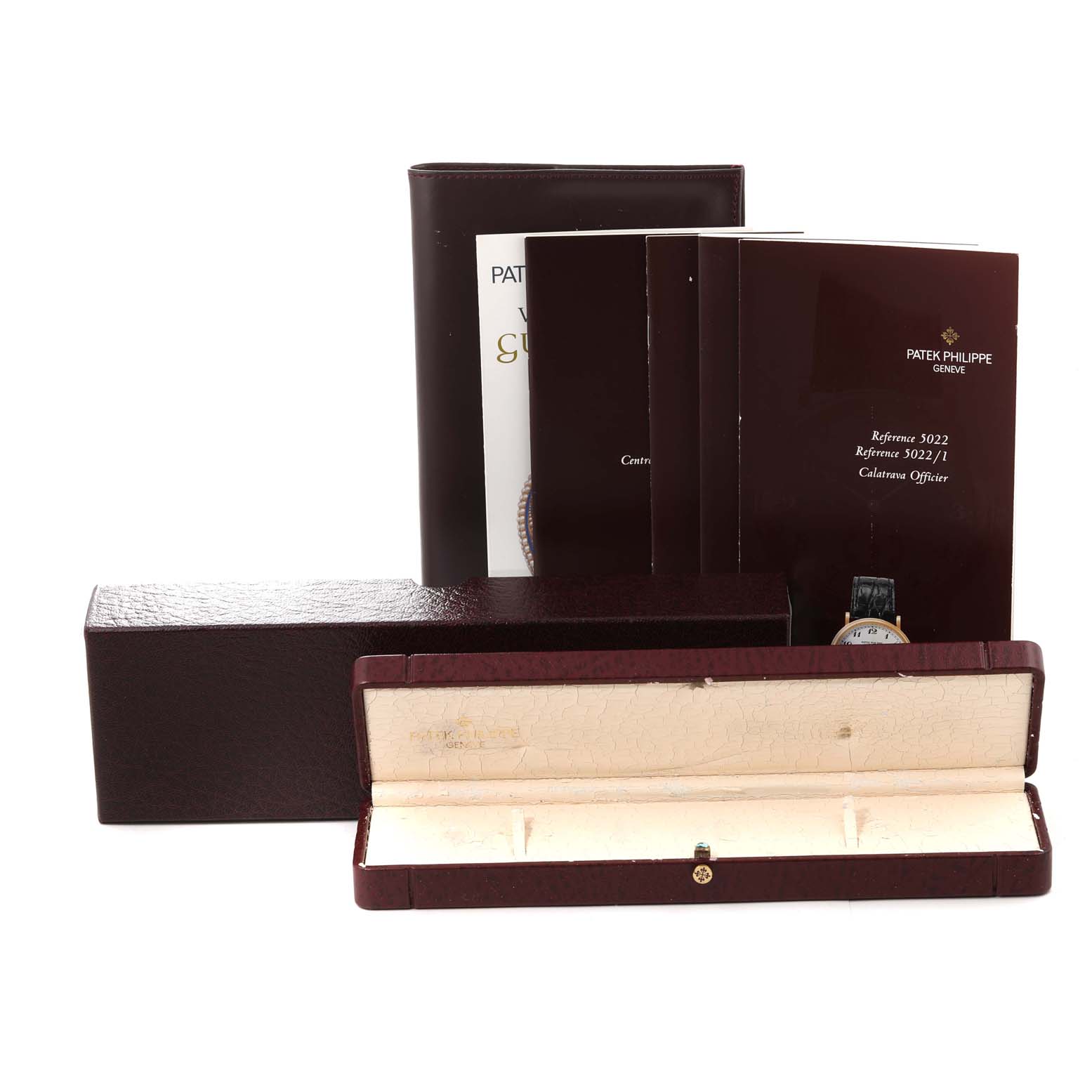 The image shows the packaging, documents, and storage case for a Patek Philippe Calatrava 5022J Men
s Yellow Gold White Dial 5022J Men
s Yellow Gold White Dial watch, viewed from the front.