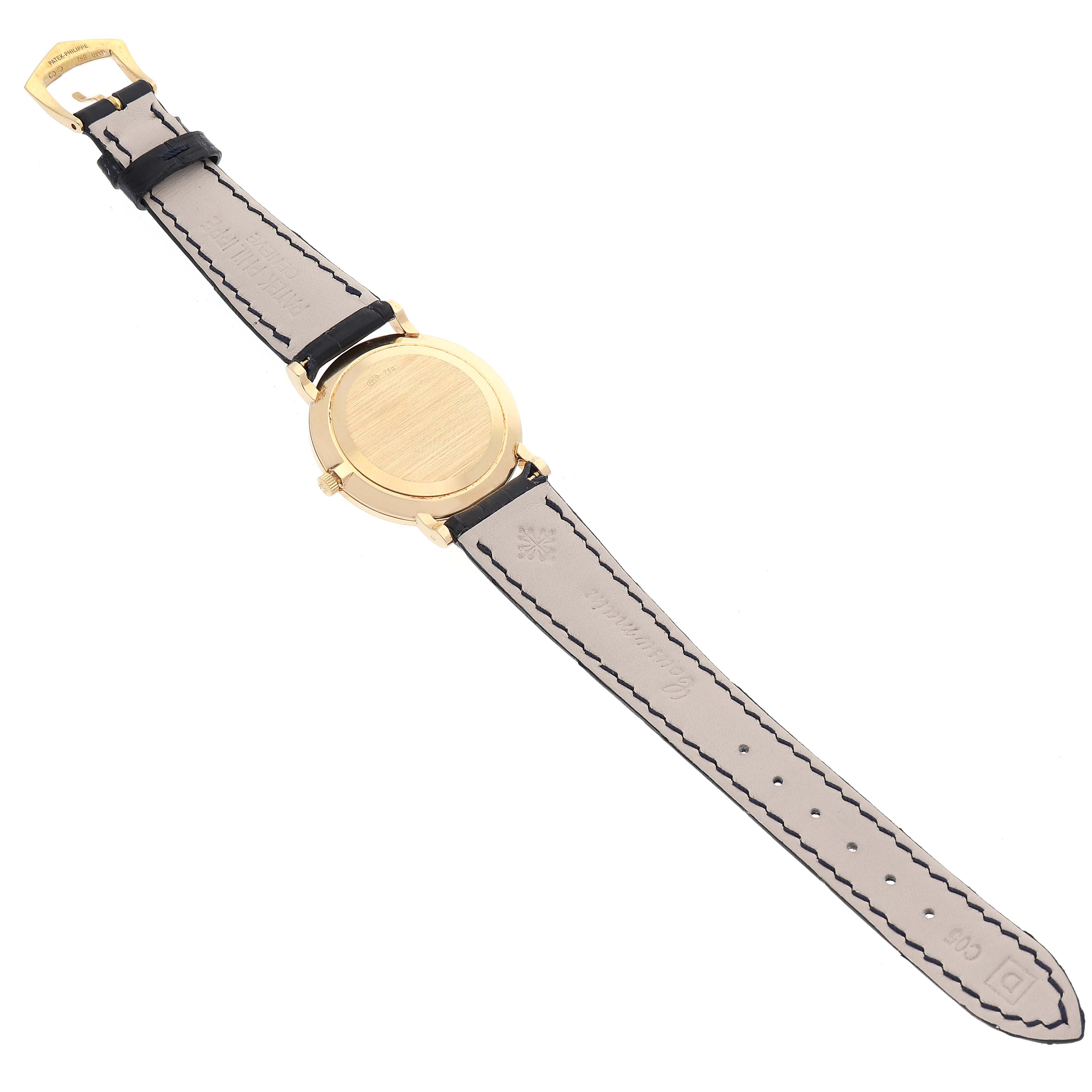 The image shows the back view of a Patek Philippe Calatrava 5022J Men
s Yellow Gold White Dial 5022J Men
s Yellow Gold White Dial watch, highlighting the leather strap and the case back.