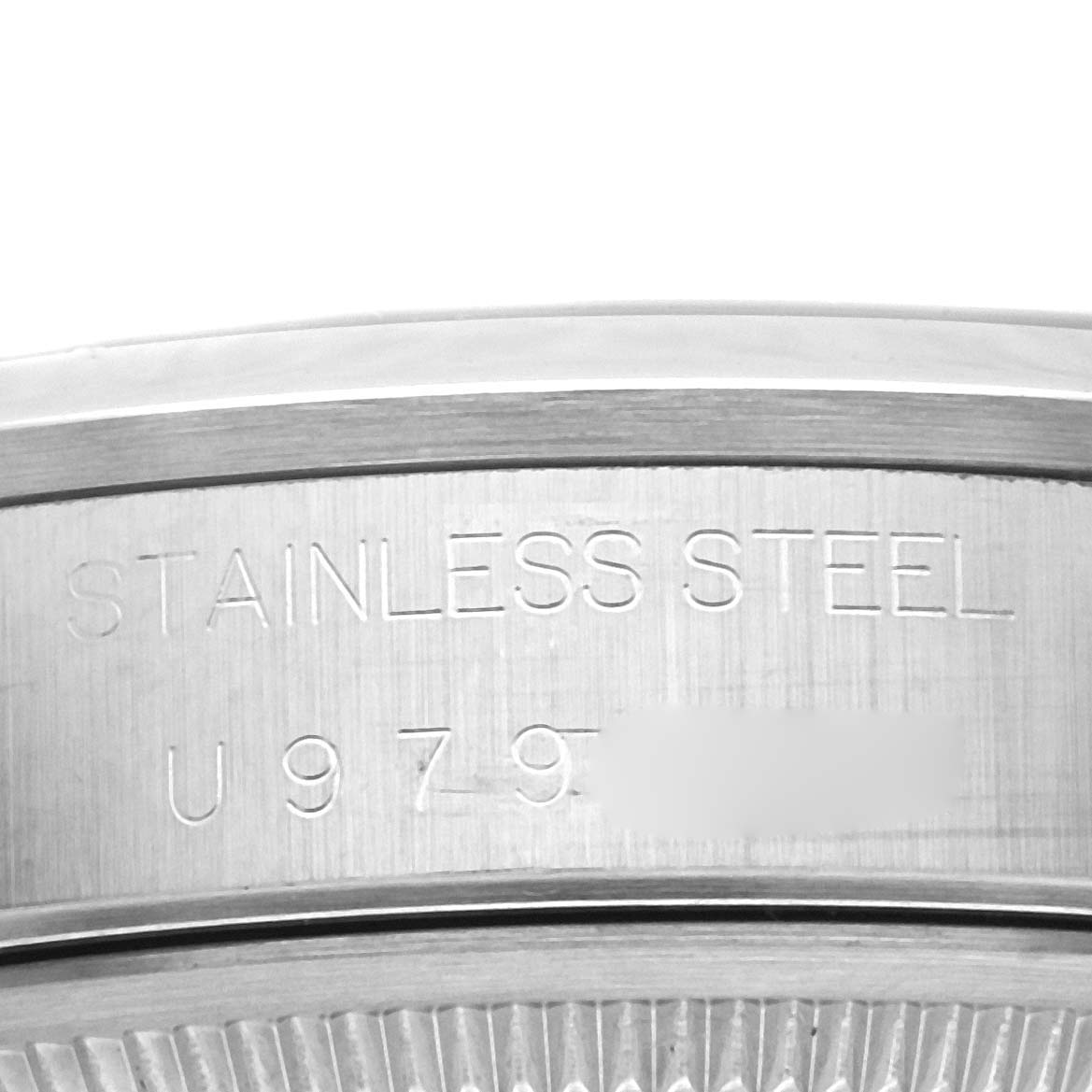 This image shows a close-up of the engraved stainless steel back of a Rolex Air-King 14000 Men's Stainless Steel Black Dial 14000 Men's Stainless Steel Black Dial watch with partial serial number.